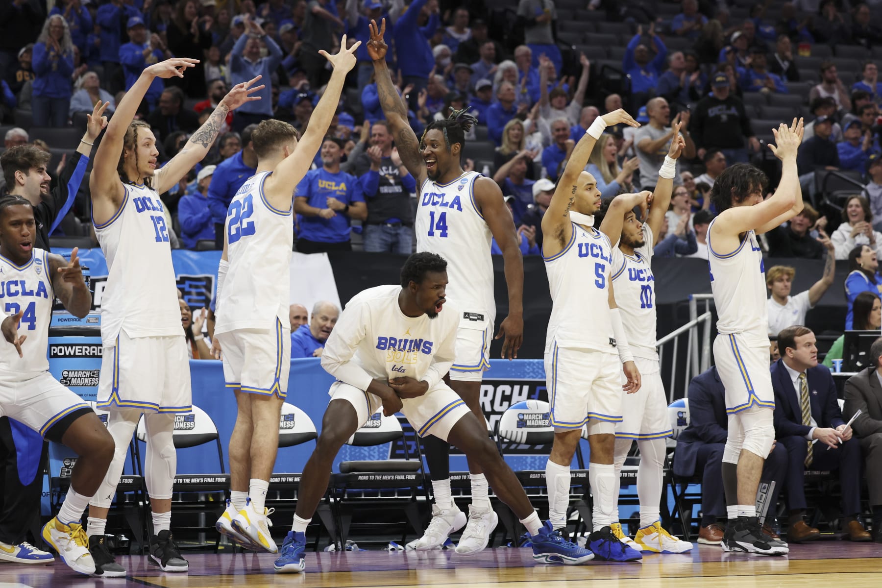 SACRAMENTO, CALIFORNIA - MARCH 16: The UCLA Bruins celebrates a three point basket during the second half of a game against the North Carolina-Asheville Bulldogs in the first round of the NCAA Men's Basketball Tournament at Golden 1 Center on March 16, 2023 in Sacramento, California. (Photo by Ezra Shaw/Getty Images)