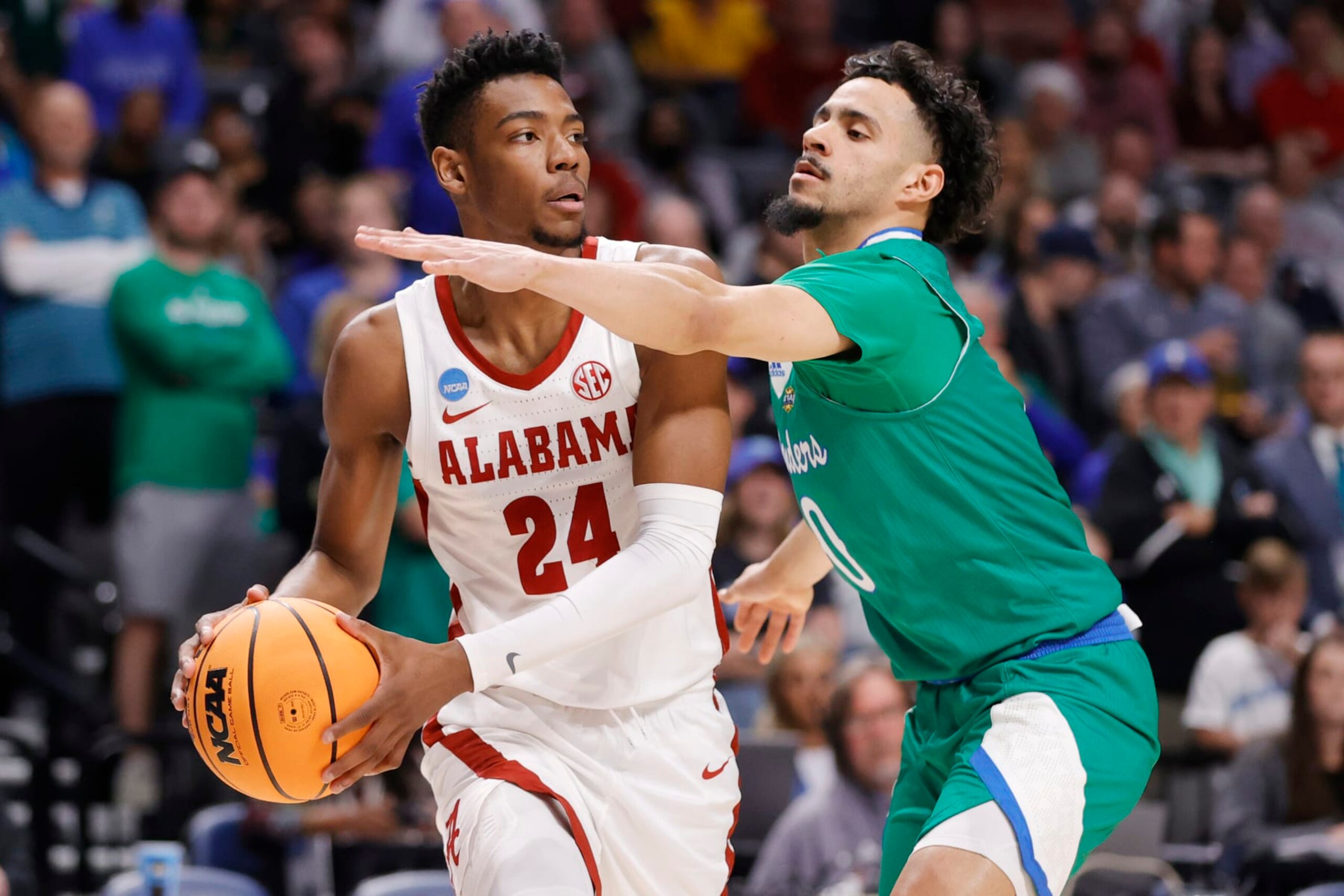 BIRMINGHAM, ALABAMA - MARCH 16: Brandon Miller #24 of the Alabama Crimson Tide looks to pass against Trevian Tennyson #0 of the Texas A&M-CC Islanders during the first half in the first round of the NCAA Men's Basketball Tournament at Legacy Arena at the BJCC on March 16, 2023 in Birmingham, Alabama. (Photo by Alex Slitz/Getty Images)