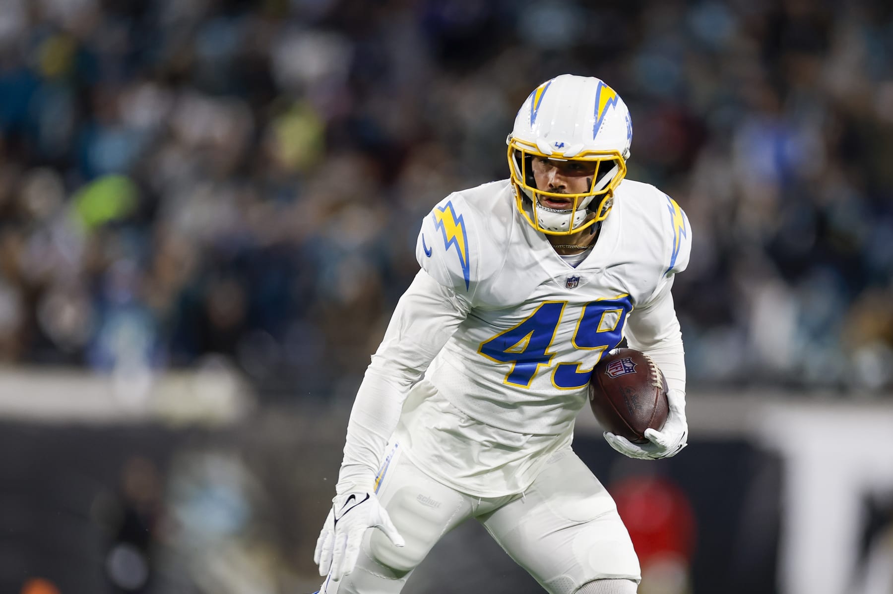JACKSONVILLE, FL - JANUARY 14: Los Angeles Chargers linebacker Drue Tranquill (49) returns an interception during the game between the Los Angeles Chargers and the Jacksonville Jaguars on January 14, 2023 at TIAA Bank Field in Jacksonville, Fl. (Photo by David Rosenblum/Icon Sportswire via Getty Images)