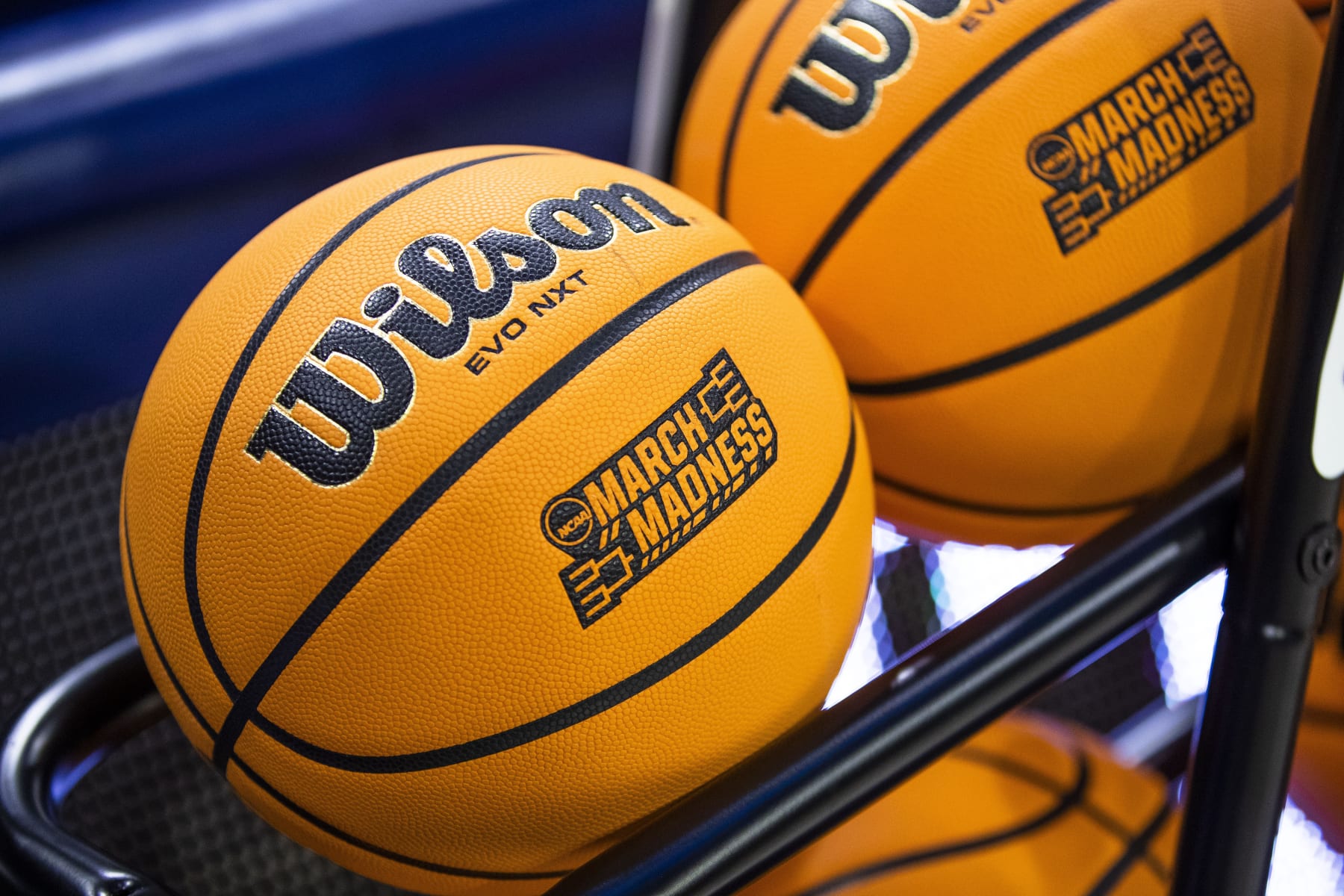 Basketball with a March Madness logo sit on a rack before a First Four game between Illinois and Mississippi State in the NCAA women's college basketball tournament Wednesday, March 15, 2023, in South Bend, Ind. (AP Photo/Michael Caterina)