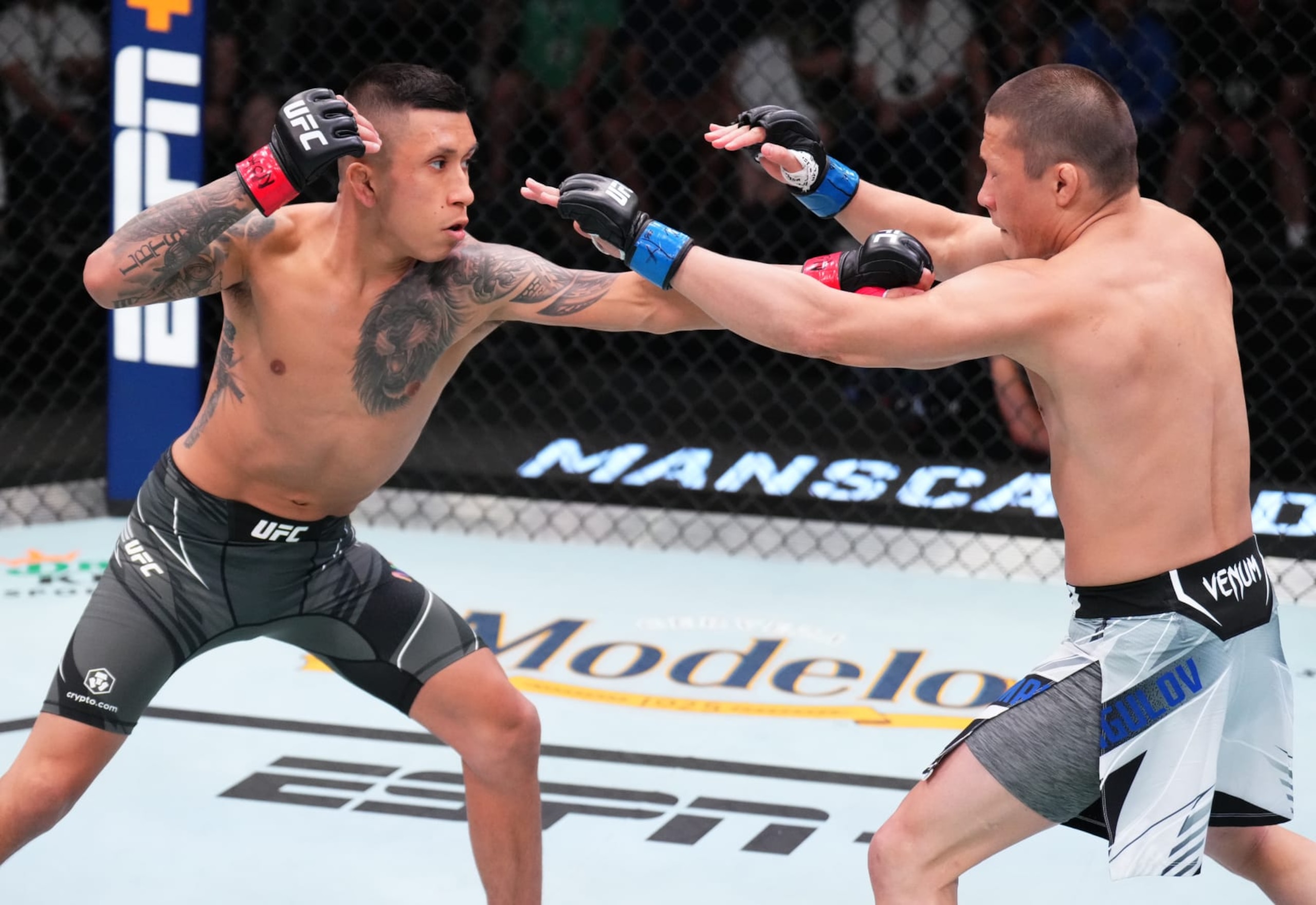 LAS VEGAS, NEVADA - JUNE 04: (L-R) Jeff Molina punches Zhalgas Zhumagulov of Kazakstan in a flyweight fight during the UFC Fight Night event at UFC APEX on June 04, 2022 in Las Vegas, Nevada. (Photo by Chris Unger/Zuffa LLC)