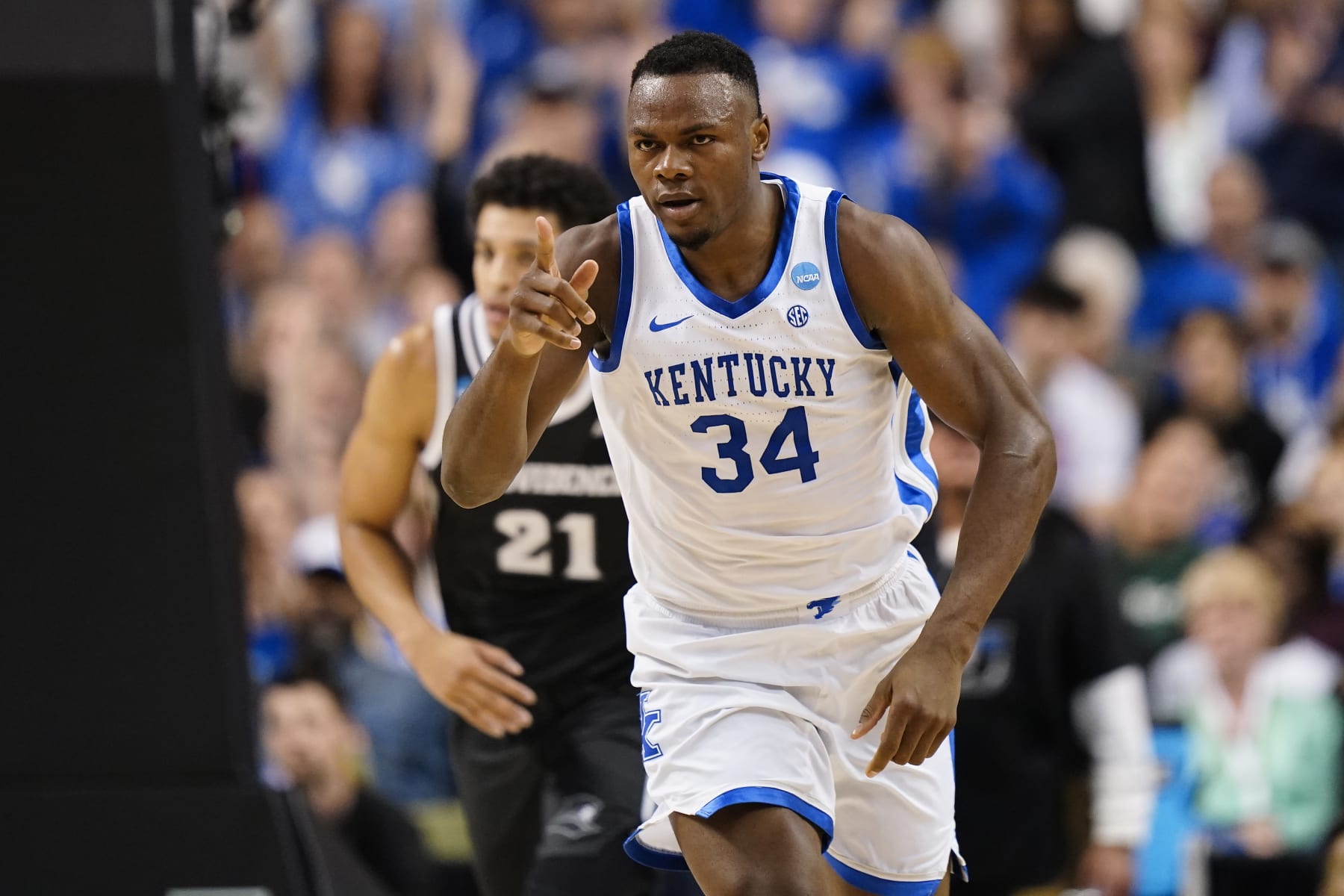 GREENSBORO, NORTH CAROLINA - MARCH 17: Oscar Tshiebwe #34 of the Kentucky Wildcats reacts after a play during the first half against the Providence Friars in the first round of the NCAA Men's Basketball Tournament at The Fieldhouse at Greensboro Coliseum on March 17, 2023 in Greensboro, North Carolina. (Photo by Jacob Kupferman/Getty Images)