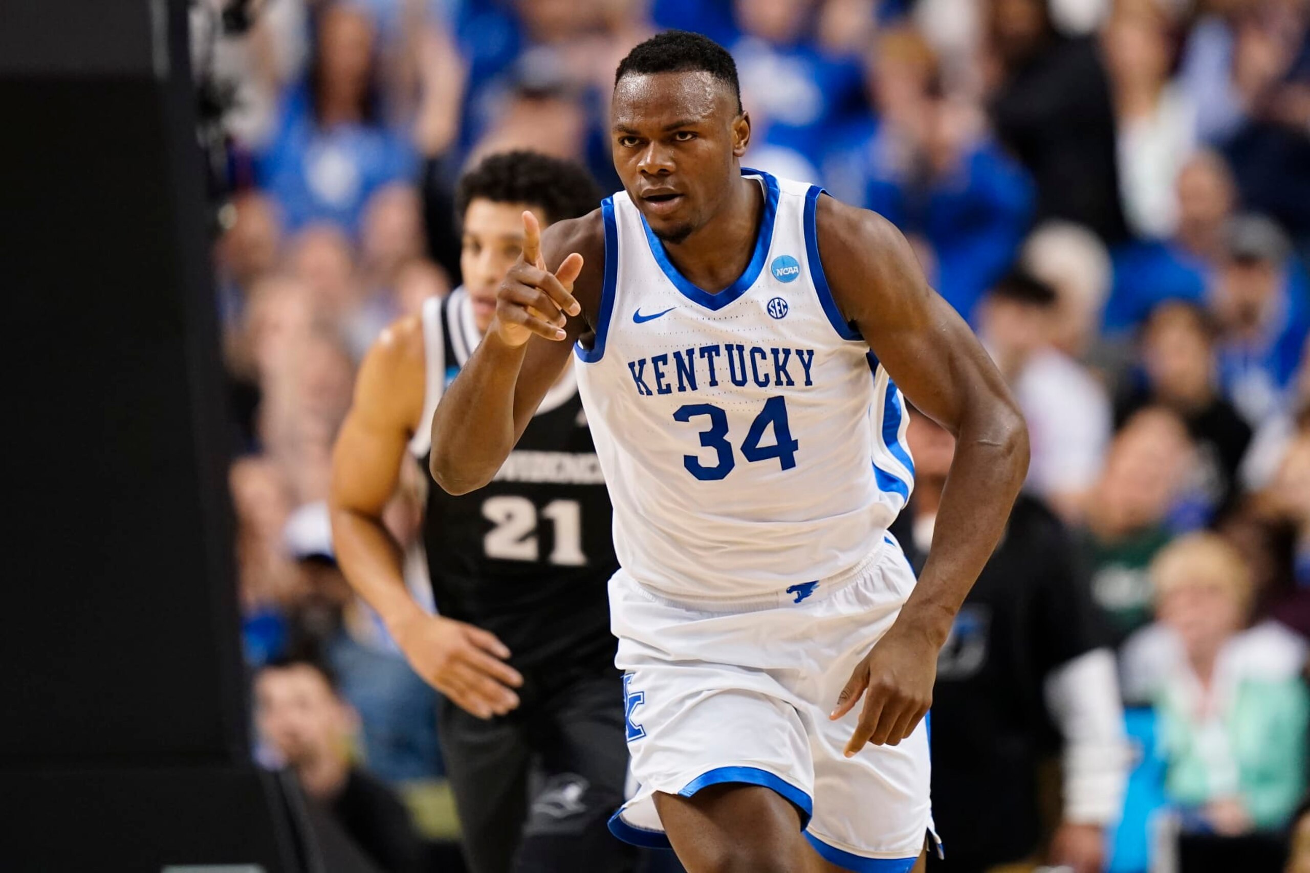 GREENSBORO, NORTH CAROLINA - MARCH 17: Oscar Tshiebwe #34 of the Kentucky Wildcats reacts after a play during the first half against the Providence Friars in the first round of the NCAA Men's Basketball Tournament at The Fieldhouse at Greensboro Coliseum on March 17, 2023 in Greensboro, North Carolina. (Photo by Jacob Kupferman/Getty Images)