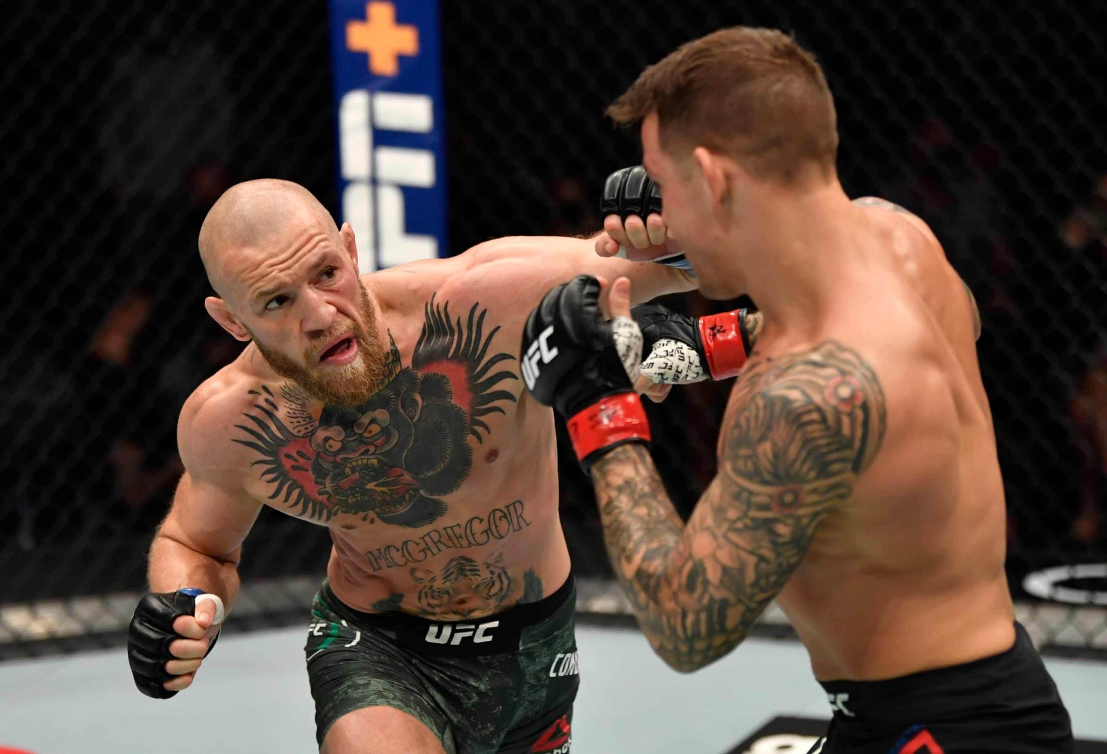 ABU DHABI, UNITED ARAB EMIRATES - JANUARY 23: In this handout image provided by the UFC, (L-R) Conor McGregor of Ireland punches Dustin Poirier in a lightweight fight during the UFC 257 event inside Etihad Arena on UFC Fight Island on January 23, 2021 in Abu Dhabi, United Arab Emirates. (Photo by Jeff Bottari/Zuffa LLC via Getty Images) ABU DHABI, UNITED ARAB EMIRATES - JANUARY 23: In this handout image provided by the UFC, (L-R) Conor McGregor of Ireland punches Dustin Poirier in a lightweight fight during the UFC 257 event inside Etihad Arena on UFC Fight Island on January 23, 2021 in Abu Dhabi, United Arab Emirates. (Photo by Jeff Bottari/Zuffa LLC via Getty Images)