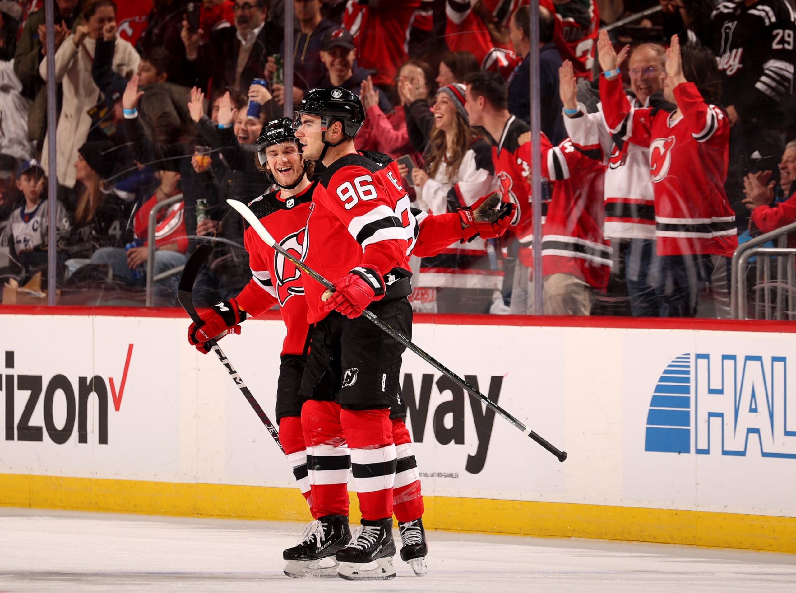 NEWARK, NEW JERSEY - MARCH 16: Timo Meier #96 of the New Jersey Devils is congratulated by teammate Dawson Mercer #91 after Meier scored in the third period against the Tampa Bay Lightning at Prudential Center on March 16, 2023 in Newark, New Jersey.  The Tampa Bay Lightning defeated the New Jersey Devils 4-3 after a shoot out. (Photo by Elsa/Getty Images)