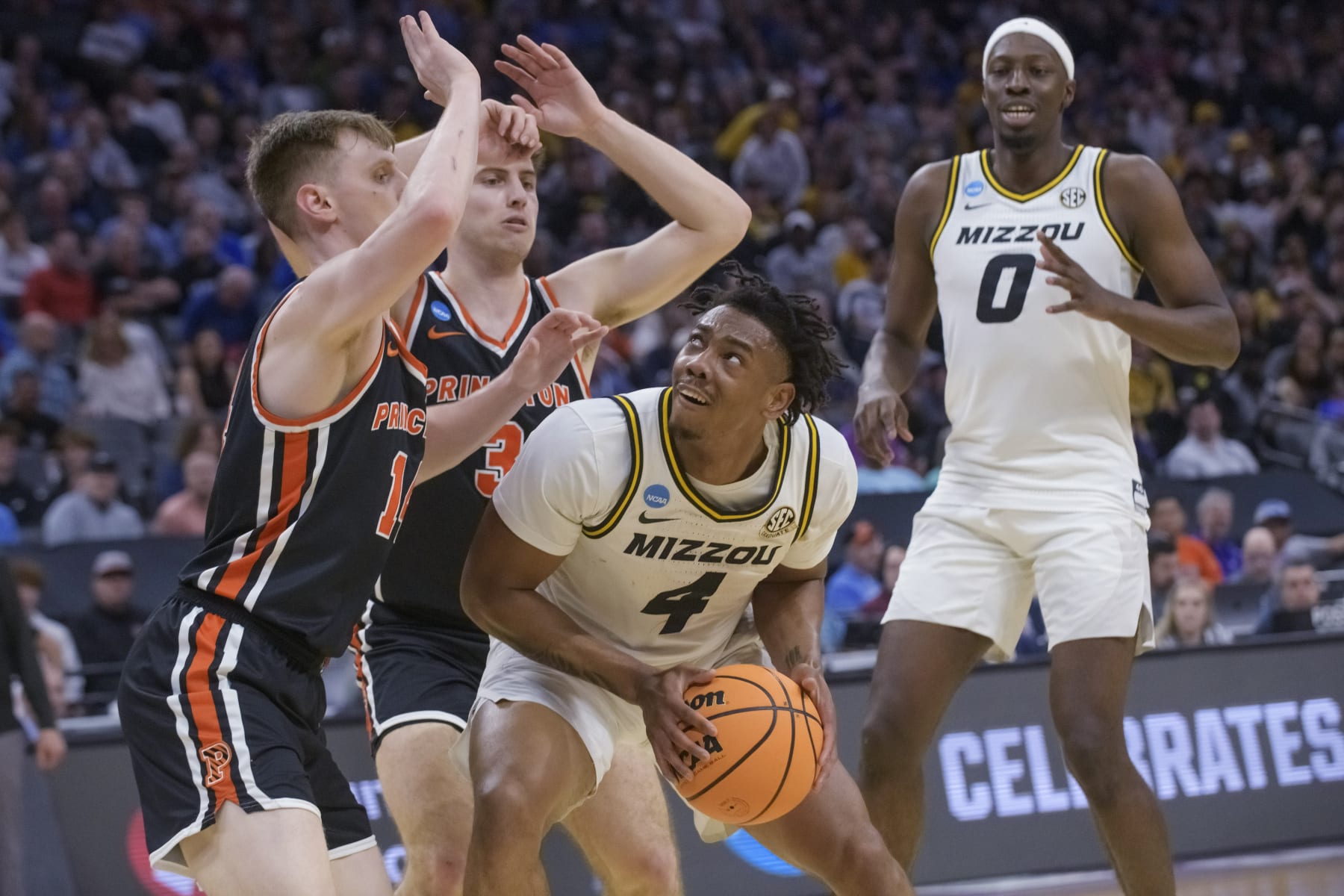 Missouri guard DeAndre Gholston (4) is guarded by Princeton guard Matt Allocco, left, and guard Ryan Langborg during the first half of a second-round college basketball game in the men's NCAA Tournament in Sacramento, Calif., Saturday, March 18, 2023. (AP Photo/Randall Benton)