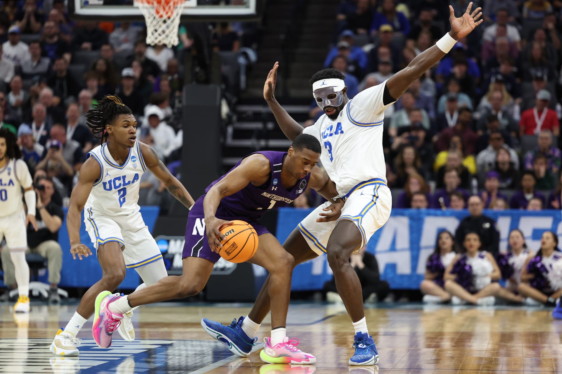 SACRAMENTO, CALIFORNIA - MARCH 18: Adem Bona #3 of the UCLA Bruins defends against Chase Audige #1 of the Northwestern Wildcats during the second half in the second round of the NCAA Men's Basketball Tournament at Golden 1 Center on March 18, 2023 in Sacramento, California. (Photo by Ezra Shaw/Getty Images)