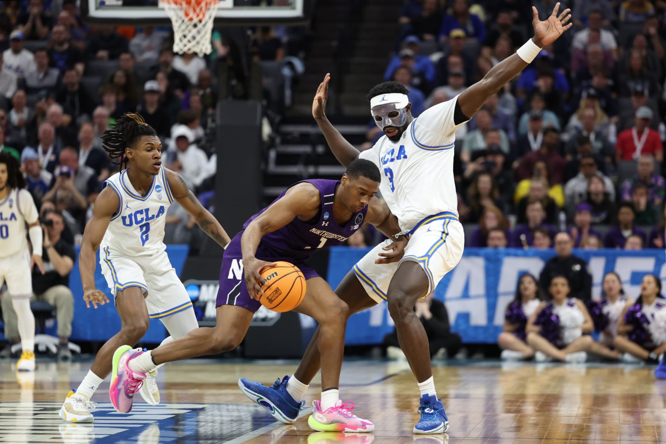 SACRAMENTO, CALIFORNIA - MARCH 18: Adem Bona #3 of the UCLA Bruins defends against Chase Audige #1 of the Northwestern Wildcats during the second half in the second round of the NCAA Men's Basketball Tournament at Golden 1 Center on March 18, 2023 in Sacramento, California. (Photo by Ezra Shaw/Getty Images)