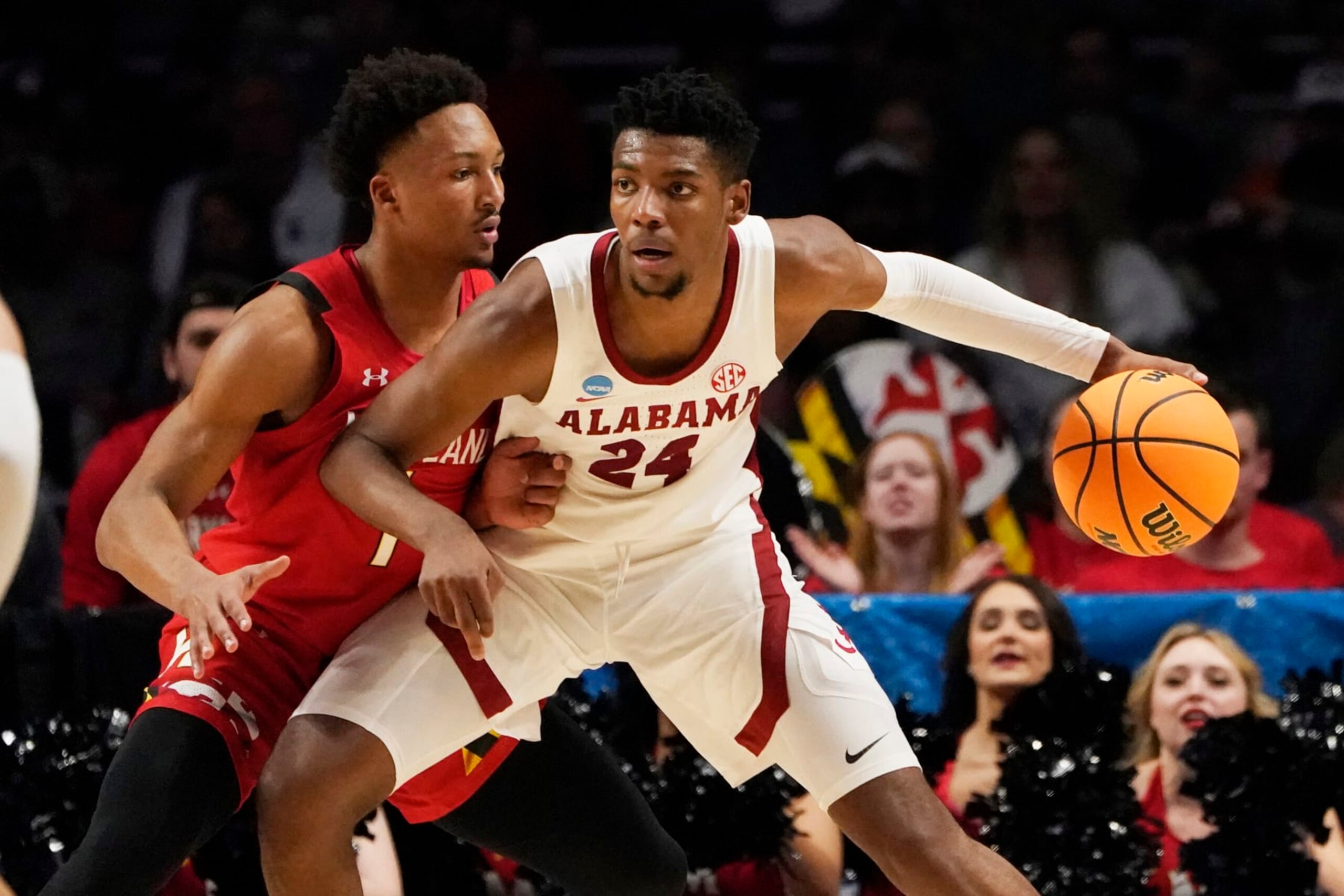 Alabama forward Brandon Miller (24) is guarded by Maryland guard Jahmir Young (1) in the first half of a second-round college basketball game in the NCAA Tournament in Birmingham, Ala., Saturday, March 18, 2023. (AP Photo/Rogelio V. Solis)
