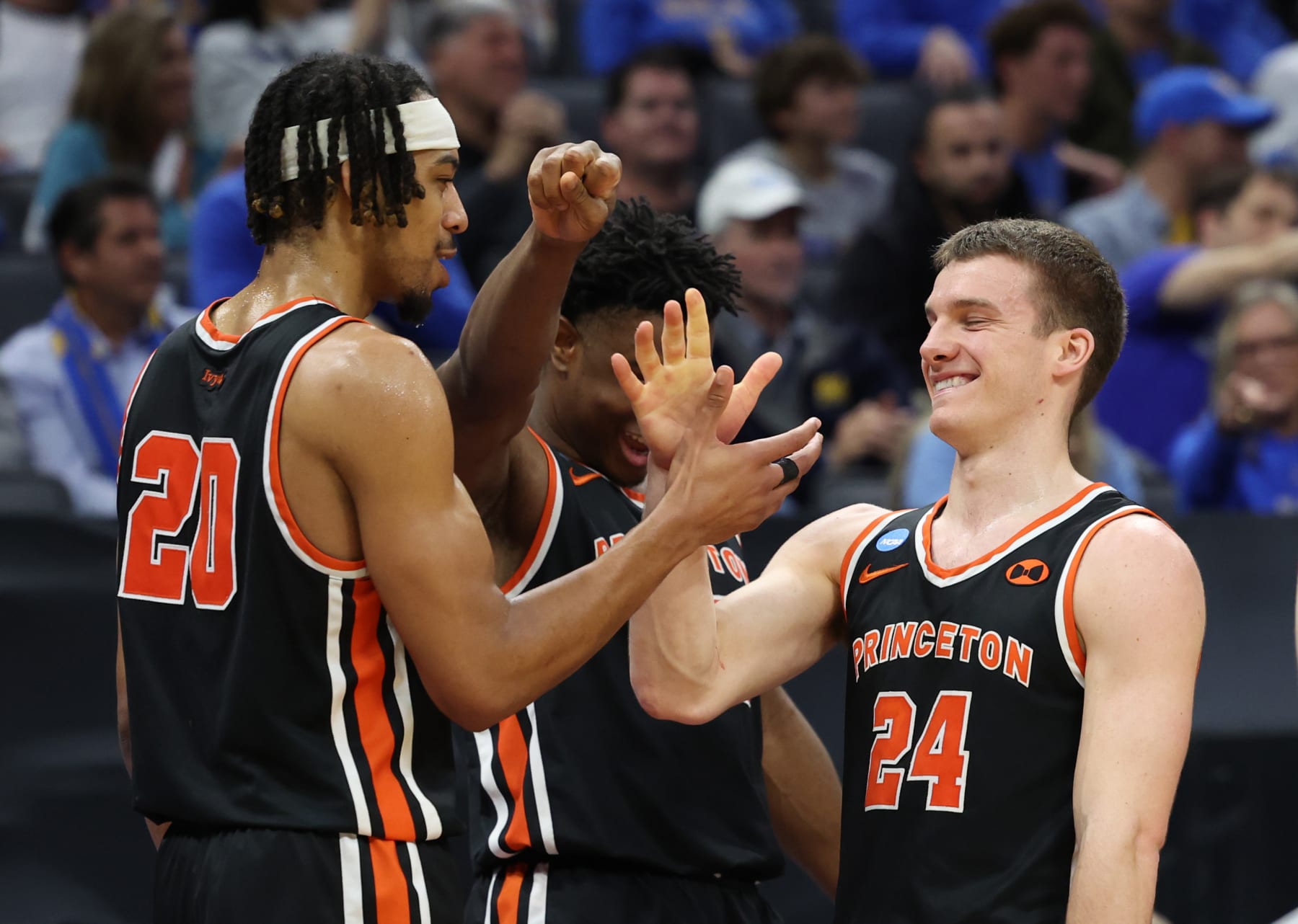 SACRAMENTO, CALIFORNIA - MARCH 18: Blake Peters #24, Tosan Evbuomwan #20, and Keeshawn Kellman #32 of the Princeton Tigers react on the bench during the second half against the Missouri Tigers in the second round of the NCAA Men's Basketball Tournament at Golden 1 Center on March 18, 2023 in Sacramento, California. (Photo by Ezra Shaw/Getty Images)