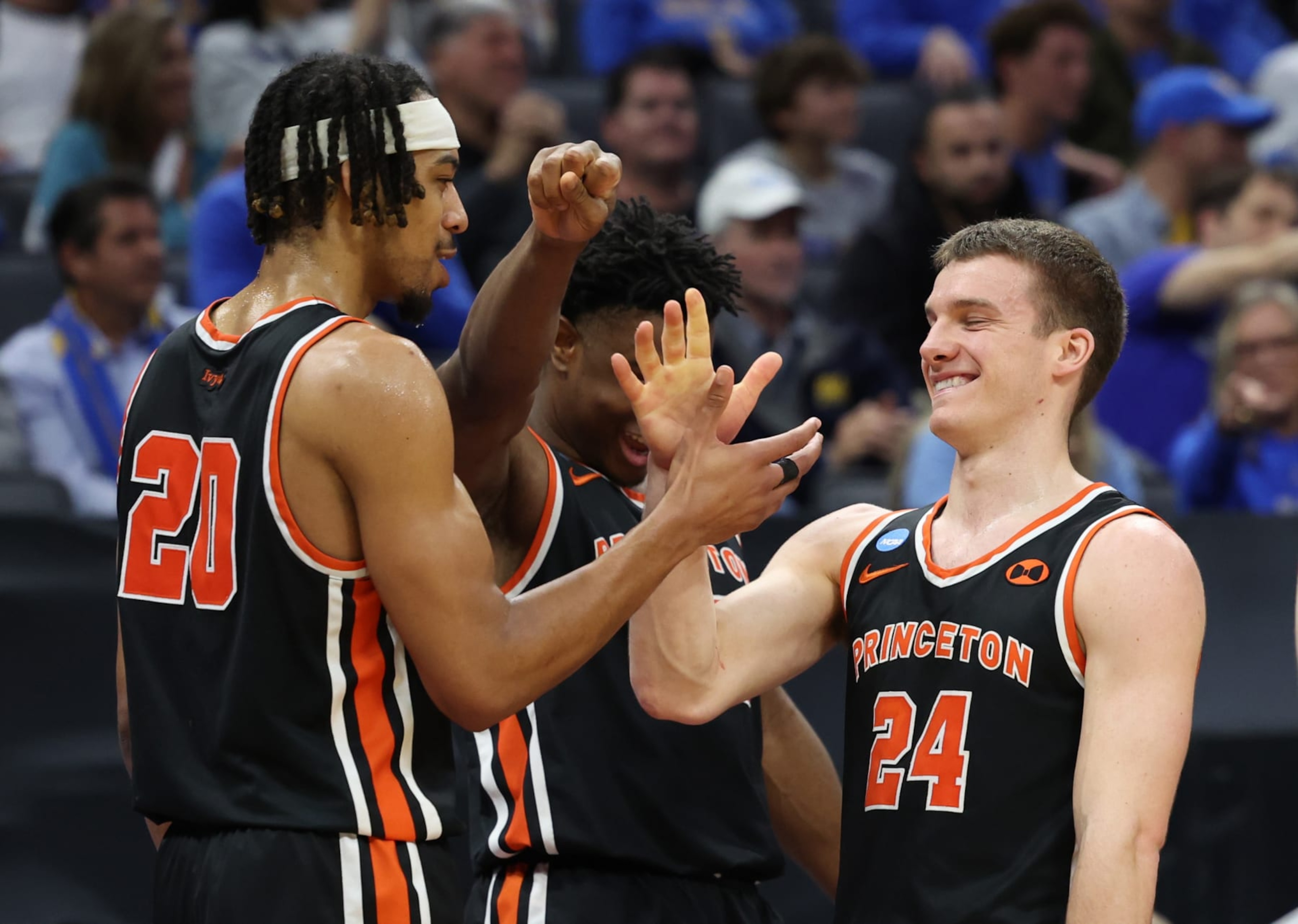SACRAMENTO, CALIFORNIA - MARCH 18: Blake Peters #24, Tosan Evbuomwan #20, and Keeshawn Kellman #32 of the Princeton Tigers react on the bench during the second half against the Missouri Tigers in the second round of the NCAA Men's Basketball Tournament at Golden 1 Center on March 18, 2023 in Sacramento, California. (Photo by Ezra Shaw/Getty Images)