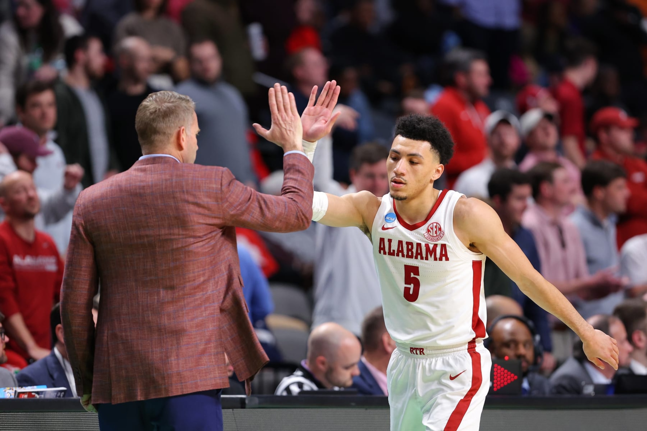 BIRMINGHAM, ALABAMA - MARCH 18: Jahvon Quinerly #5 of the Alabama Crimson Tide gives head coach Nate Oats a high five during the second half against the Maryland Terrapins in the second round of the NCAA Men's Basketball Tournament at Legacy Arena at the BJCC on March 18, 2023 in Birmingham, Alabama. (Photo by Kevin C. Cox/Getty Images)