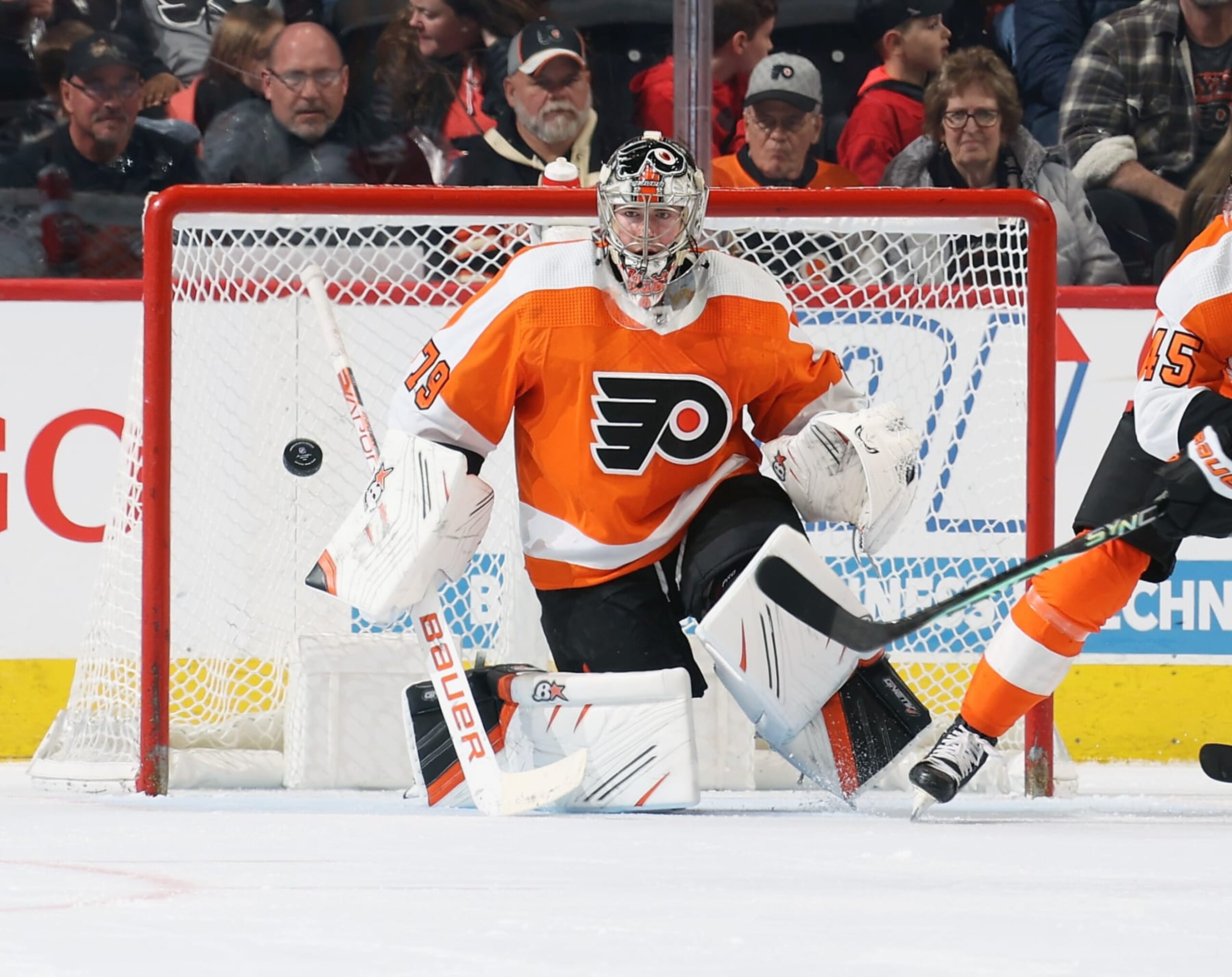 PHILADELPHIA, PENNSYLVANIA - MARCH 05: Carter Hart #79 of the Philadelphia Flyers keeps his eyes on the airborn puck in the third period against the Detroit Red Wings at the Wells Fargo Center on March 5, 2023 in Philadelphia, Pennsylvania.  (Photo by Len Redkoles/NHLI via Getty Images)