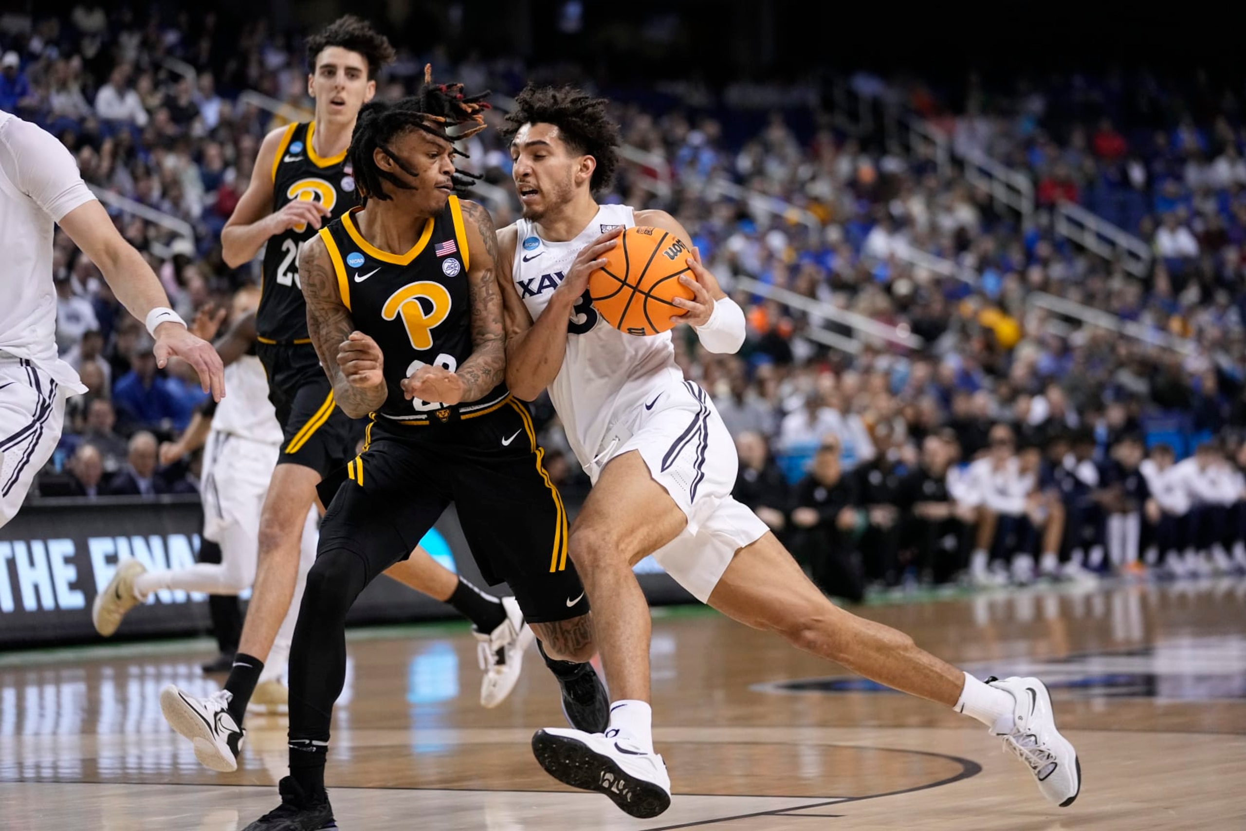Pitt's Nike Sibande trying to defend Xavier's Colby Jones