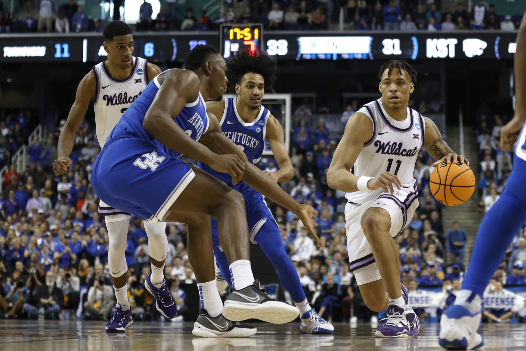 GREENSBORO, NORTH CAROLINA - MARCH 19: Keyontae Johnson #11 of the Kansas State Wildcats dribbles against Oscar Tshiebwe #34 of the Kentucky Wildcats during the second half in the second round of the NCAA Men's Basketball Tournament at The Fieldhouse at Greensboro Coliseum on March 19, 2023 in Greensboro, North Carolina. (Photo by Jared C. Tilton/Getty Images)