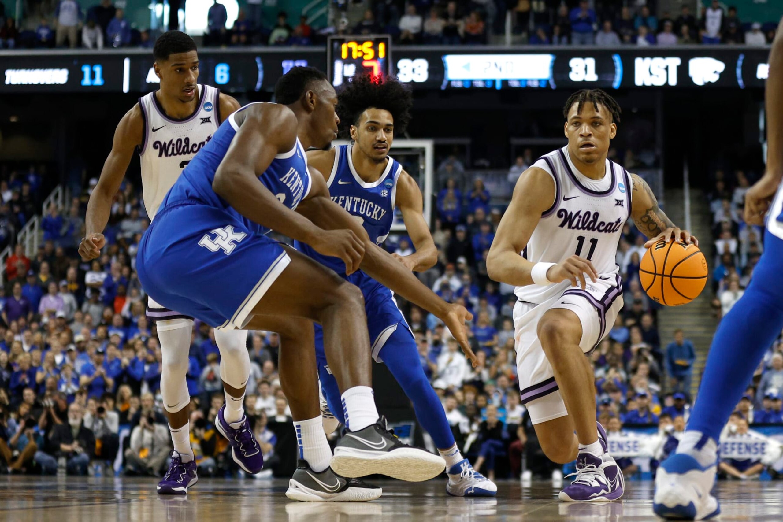 GREENSBORO, NORTH CAROLINA - MARCH 19: Keyontae Johnson #11 of the Kansas State Wildcats dribbles against Oscar Tshiebwe #34 of the Kentucky Wildcats during the second half in the second round of the NCAA Men's Basketball Tournament at The Fieldhouse at Greensboro Coliseum on March 19, 2023 in Greensboro, North Carolina. (Photo by Jared C. Tilton/Getty Images)
