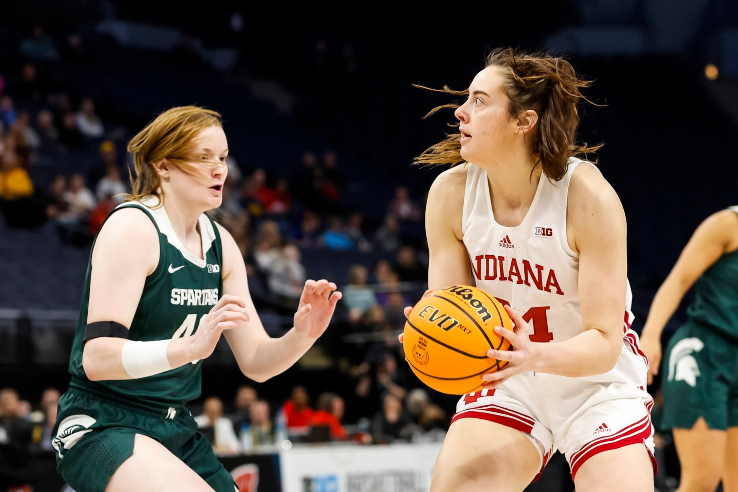 MINNEAPOLIS, MN - MARCH 03: Mackenzie Holmes #54 of the Indiana Hoosiers goes to the basket while Julia Ayrault #40 of the Michigan State Spartans defends in the second half of the game in the quarterfinals of the Big Ten Women's Basketball Tournament at Target Center on March 3, 2023 in Minneapolis, Minnesota. The Hoosiers defeated the Spartans 94-85. (Photo by David Berding/Getty Images)