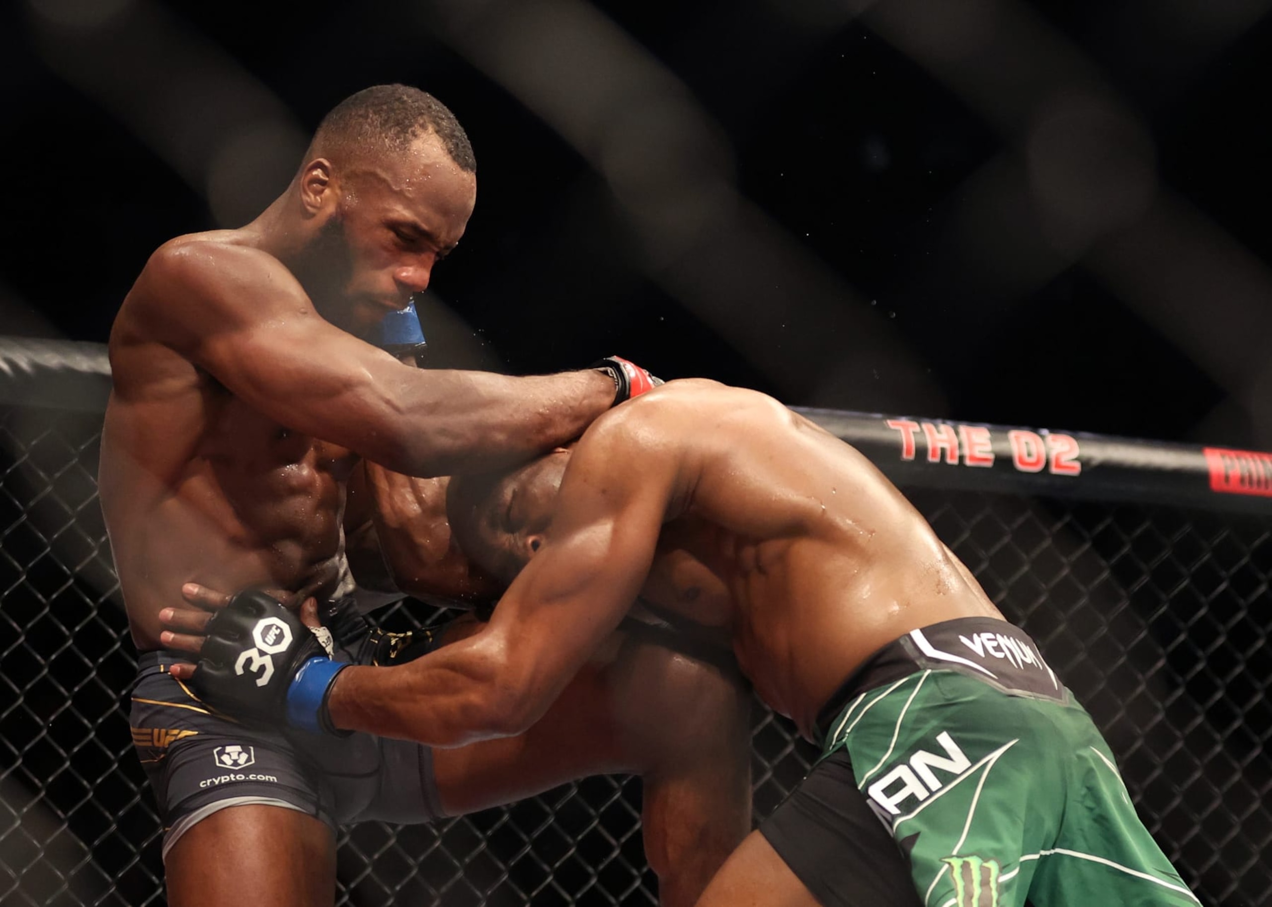 Leon Edwards throws a knee at Kamaru Usman.