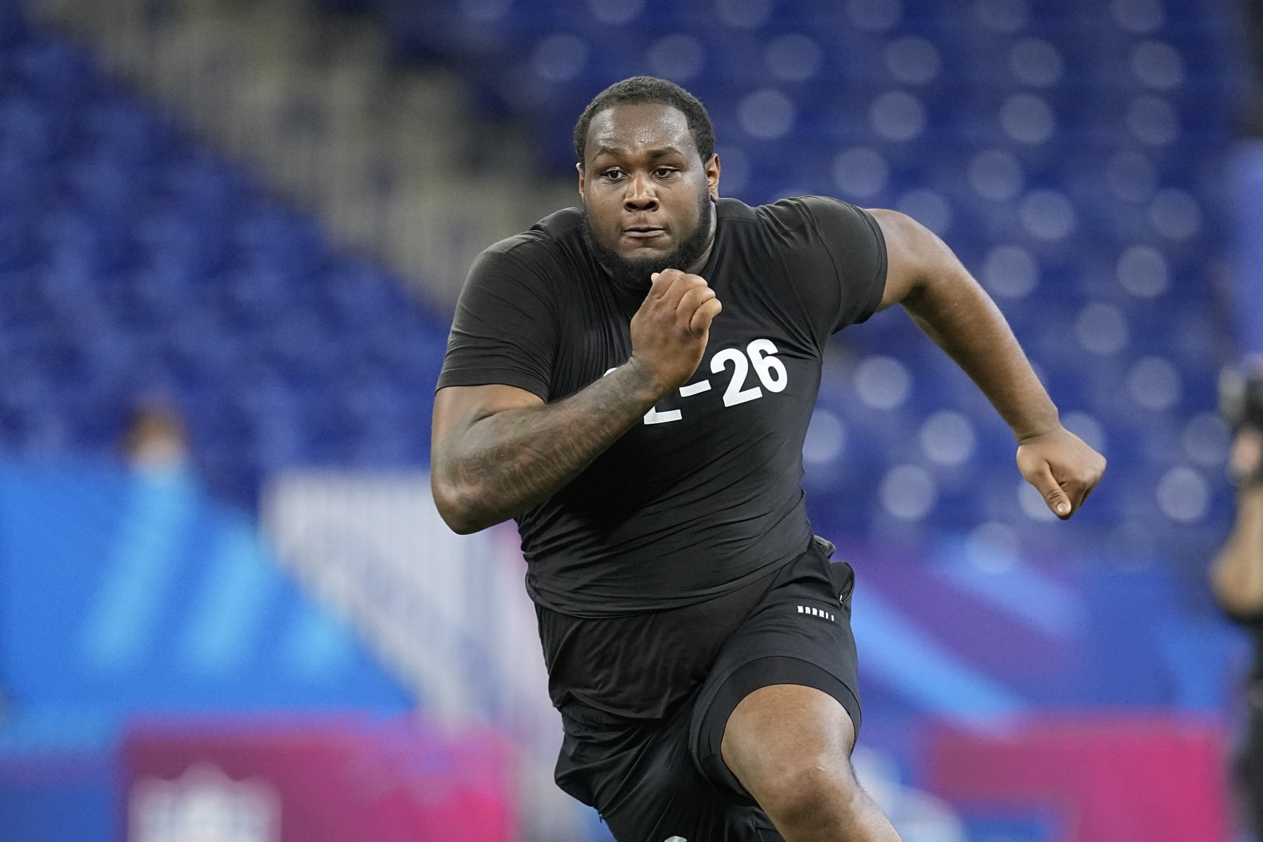 Ohio State offensive lineman Dawand Jones runs a drill at the NFL football scouting combine in Indianapolis, Sunday, March 5, 2023. (AP Photo/Darron Cummings)