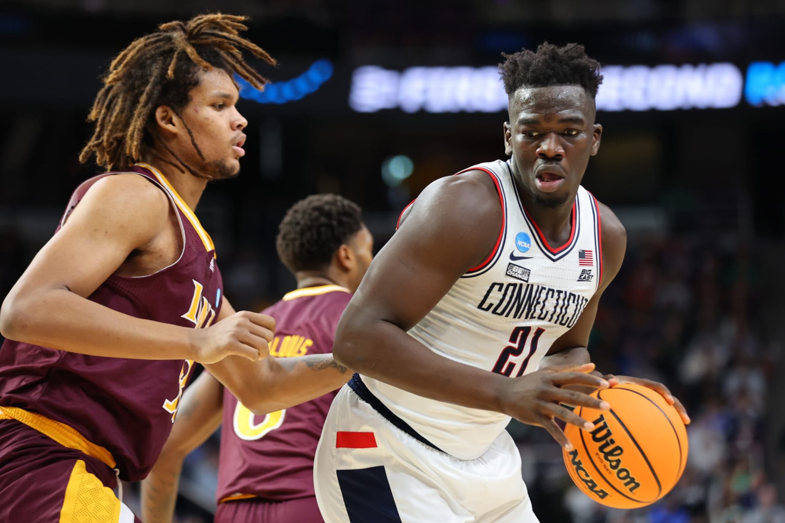 ALBANY, NY - MARCH 17: Adama Sanogo #21 of the Connecticut Huskies dribbles against Silas Sunday #33 of the Iona Gaels during the first round of the 2023 NCAA Men's Basketball Tournament held at MVP Arena on March 17, 2023 in Albany, New York. (Photo by C. Morgan Engel/NCAA Photos via Getty Images)