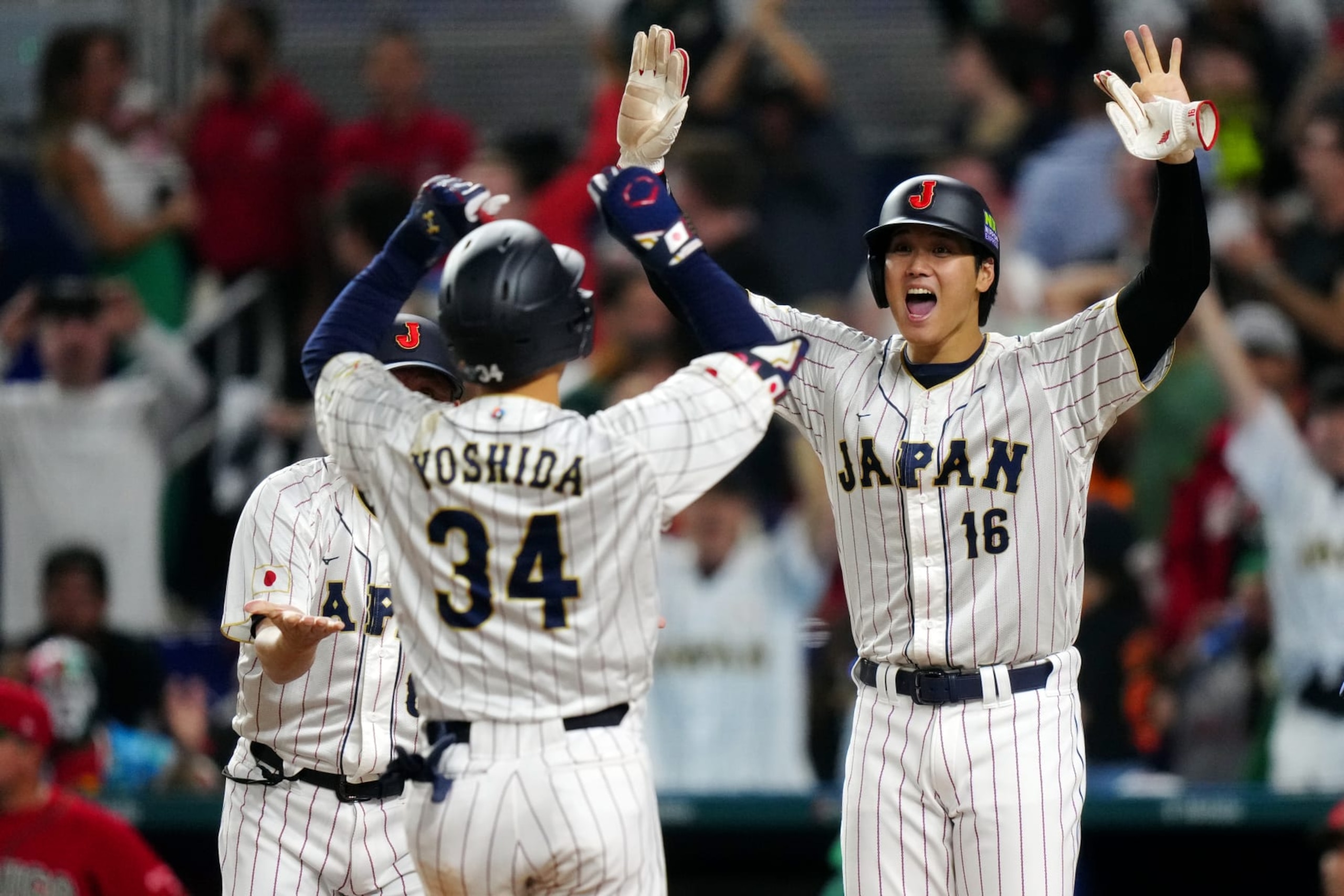 MIAMI, FL - MARCH 20:  Masataka Yoshida #34 of Team Japan is greeted at home plate by teammate Shohei Ohtani #16 after hitting a three-run home run in the eighth inning during the 2023 World Baseball Classic Semifinal game between Team Mexico and Team Japan at loanDepot Park on Monday, March 20, 2023 in Miami, Florida. (Photo by Daniel Shirey/WBCI/MLB Photos via Getty Images)