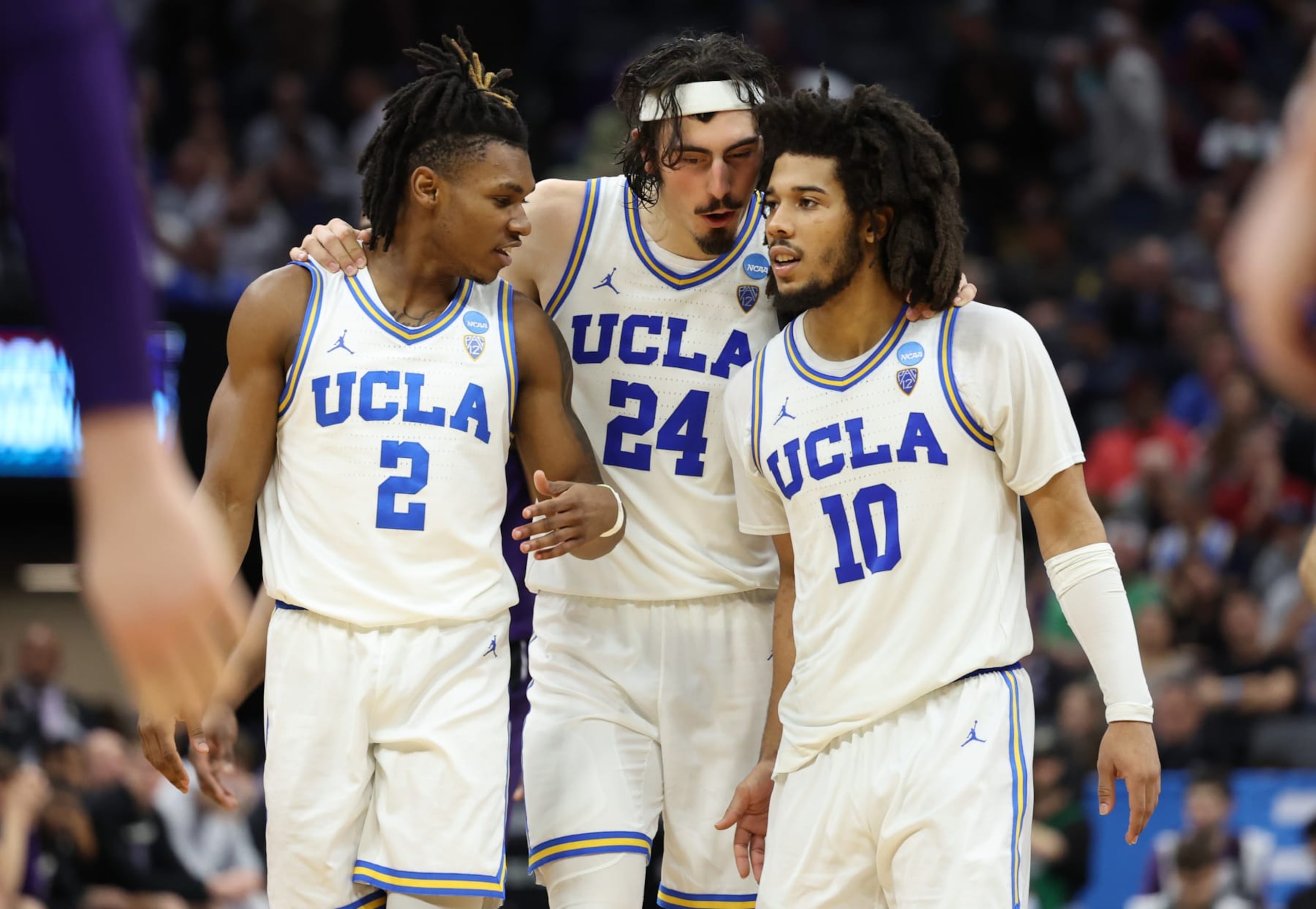 SACRAMENTO, CALIFORNIA - MARCH 18: Dylan Andrews #2, Jaime Jaquez Jr. #24, and Tyger Campbell #10 of the UCLA Bruins talk during the second half against the Northwestern Wildcats in the second round of the NCAA Men's Basketball Tournament at Golden 1 Center on March 18, 2023 in Sacramento, California. (Photo by Ezra Shaw/Getty Images)