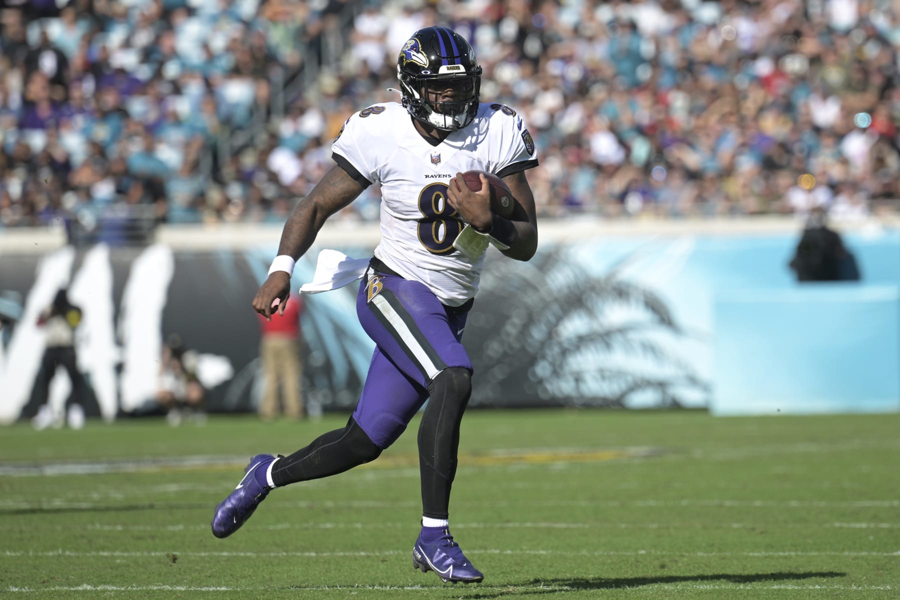 Baltimore Ravens quarterback Lamar Jackson (8) scrambles for yardage during the first half of an NFL football game against the Jacksonville Jaguars, Sunday, Nov. 27, 2022, in Jacksonville, Fla. (AP Photo/Phelan M. Ebenhack)