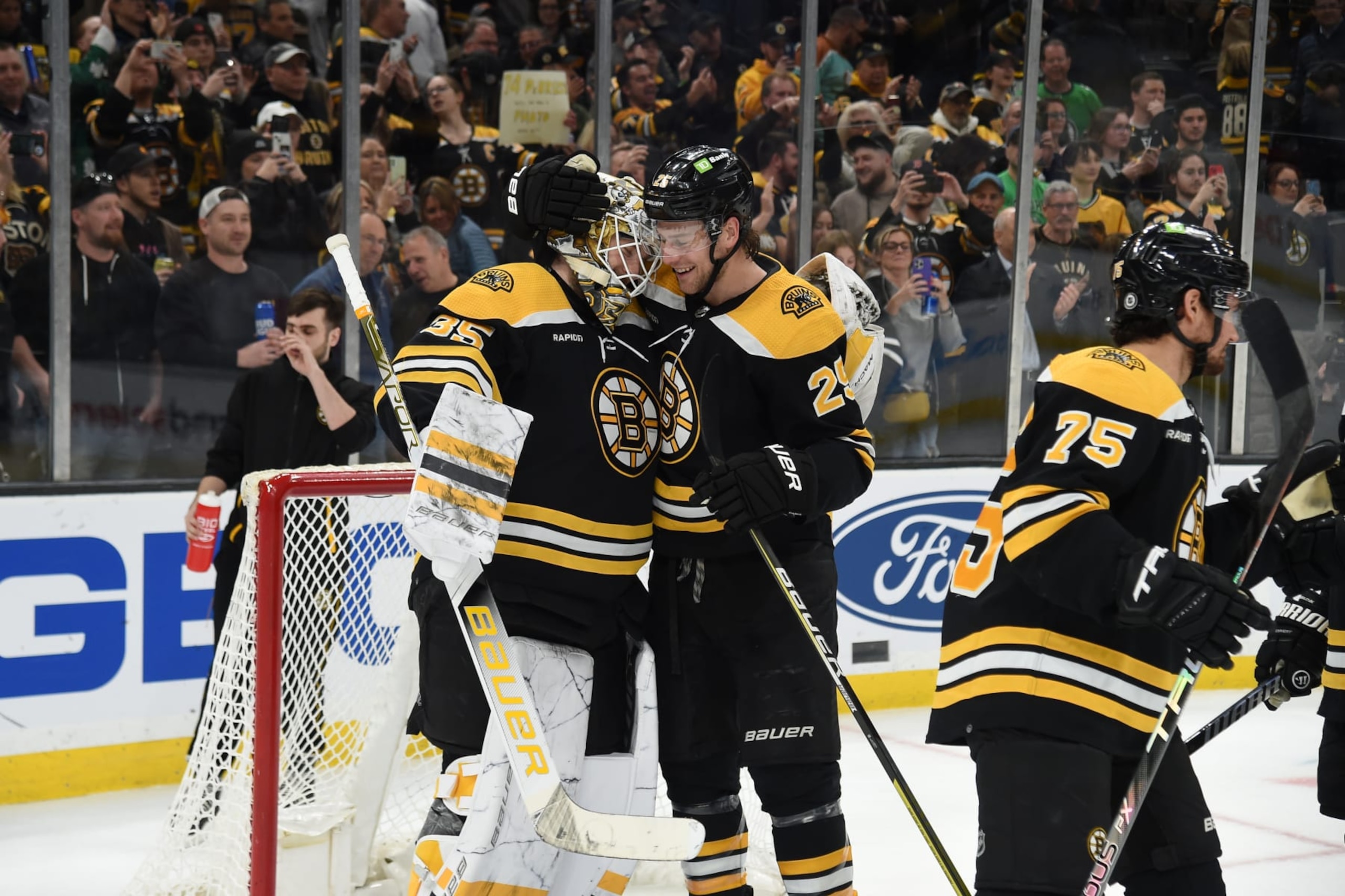 BOSTON, MASSACHUSETTS - MARCH 21: Linus Ullmark #35 and Brandon Carlo #25 of the Boston Bruins celebrate the win against the Ottawa Senators at the TD Garden on March 21, 2023 in Boston, Massachusetts. (Photo by Steve Babineau/NHLI via Getty Images)