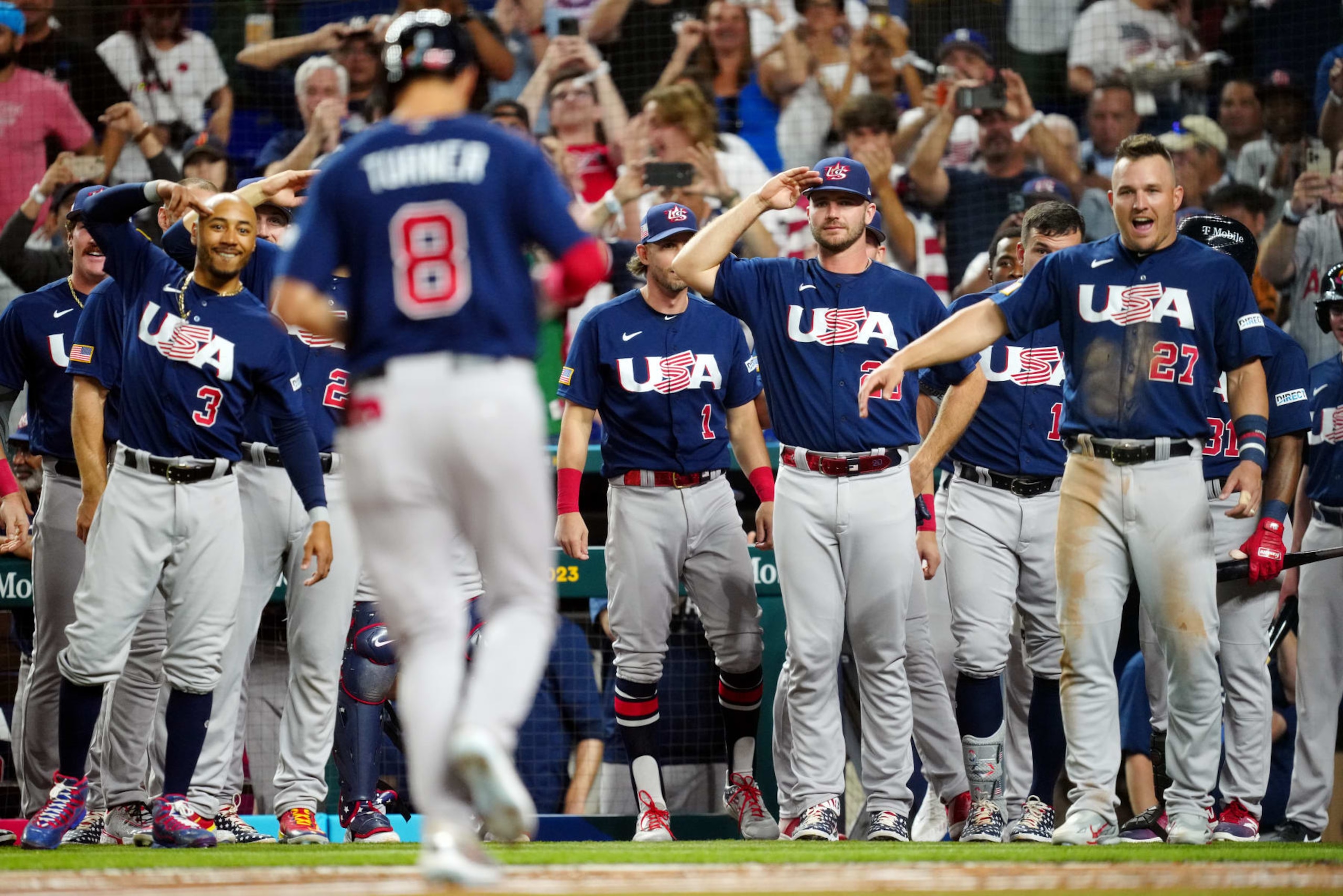 MIAMI, FL - MARCH 21:  Trea Turner #8 of Team USA is greeted by teammates after hitting a solo home run in the second inning during the 2023 World Baseball Classic Championship game between Team USA and Team Japan at loanDepot Park on Tuesday, March 21, 2023 in Miami, Florida. (Photo by Mary DeCicco/WBCI/MLB Photos via Getty Images)