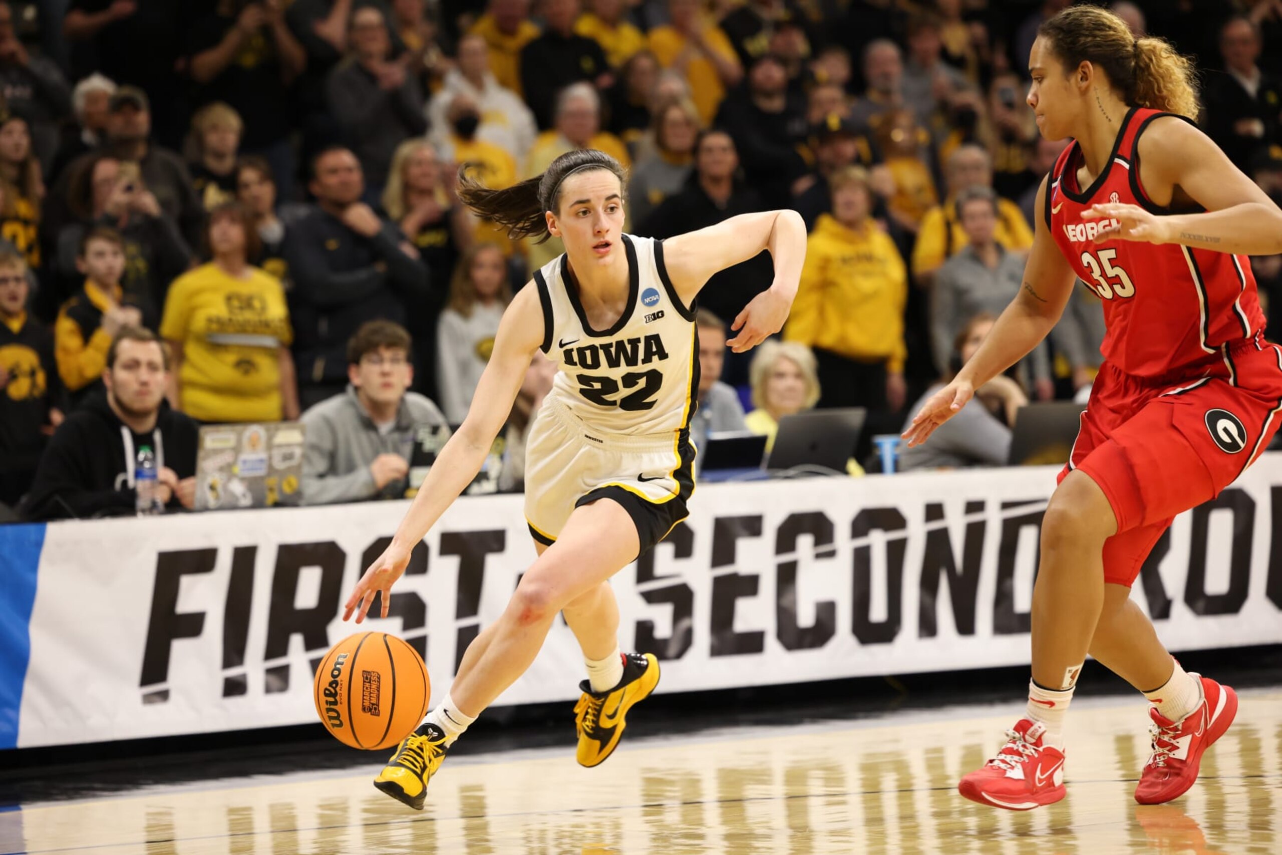 IOWA CITY, IA - MARCH 19: Caitlin Clark #22 of the Iowa Hawkeyes dribbles the ball up court past Javyn Nicholson #35 of the Georgia Bulldogs in the second half during the second round of the 2023 NCAA Women's Basketball Tournament held at Carver-Hawkeye Arena on March 19, 2023 in Iowa City, Iowa. (Photo by Rebecca Gratz/NCAA Photos via Getty Images)