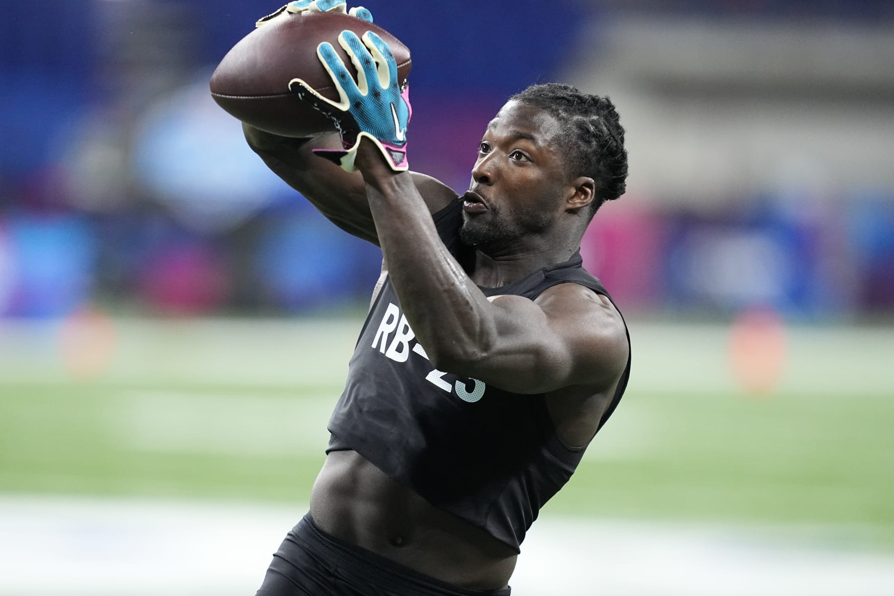 Tulane running back Tyjae Spears runs a drill at the NFL football scouting combine in Indianapolis, Sunday, March 5, 2023. (AP Photo/Darron Cummings)