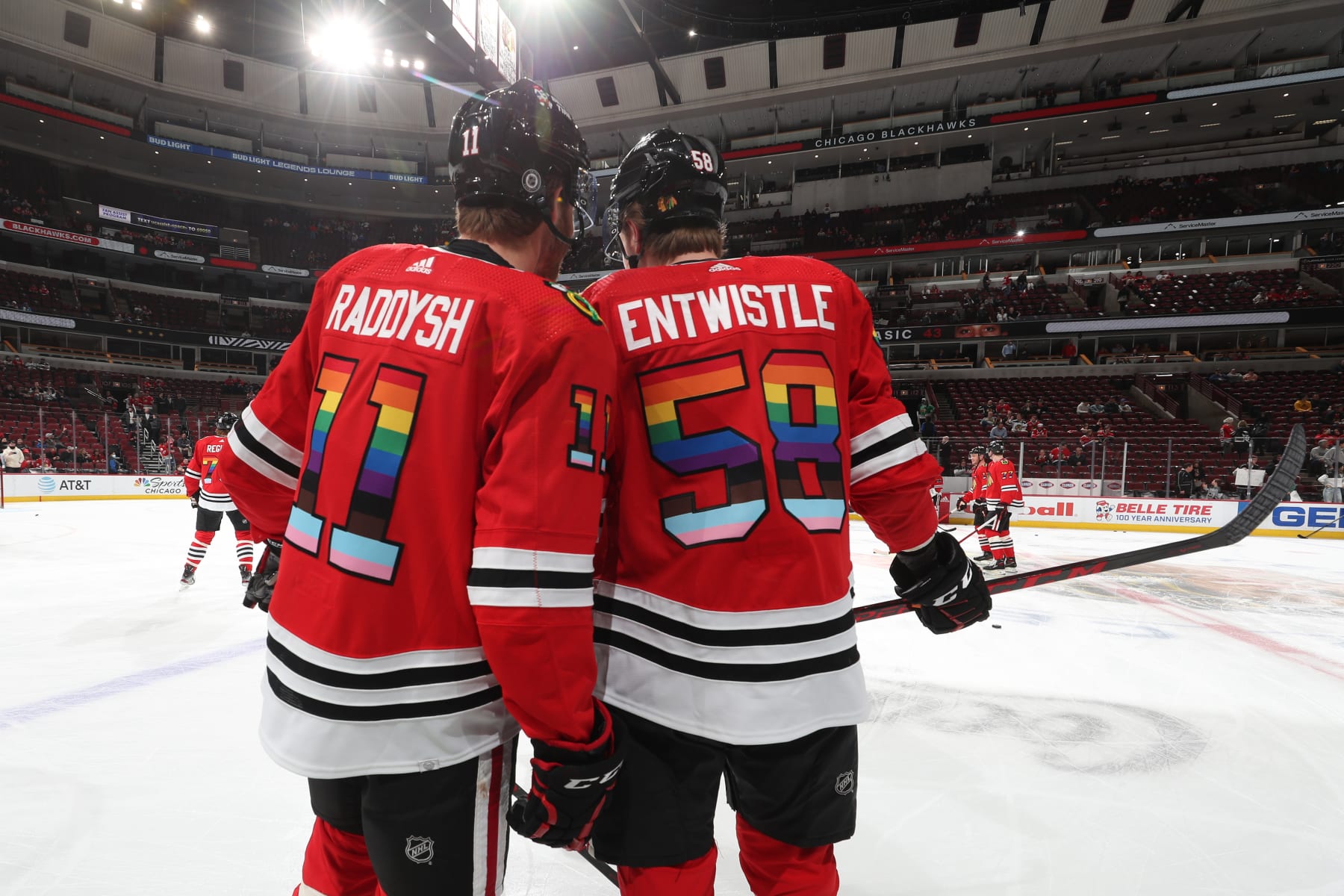 CHICAGO, ILLINOIS - APRIL 12: Taylor Raddysh #11 and MacKenzie Entwistle #58 of the Chicago Blackhawks warm up with rainbow colors on their jersey in honor of Pride Night, prior to the game against the Los Angeles Kings at United Center on April 12, 2022 in Chicago, Illinois. (Photo by Chase Agnello-Dean/NHLI via Getty Images)