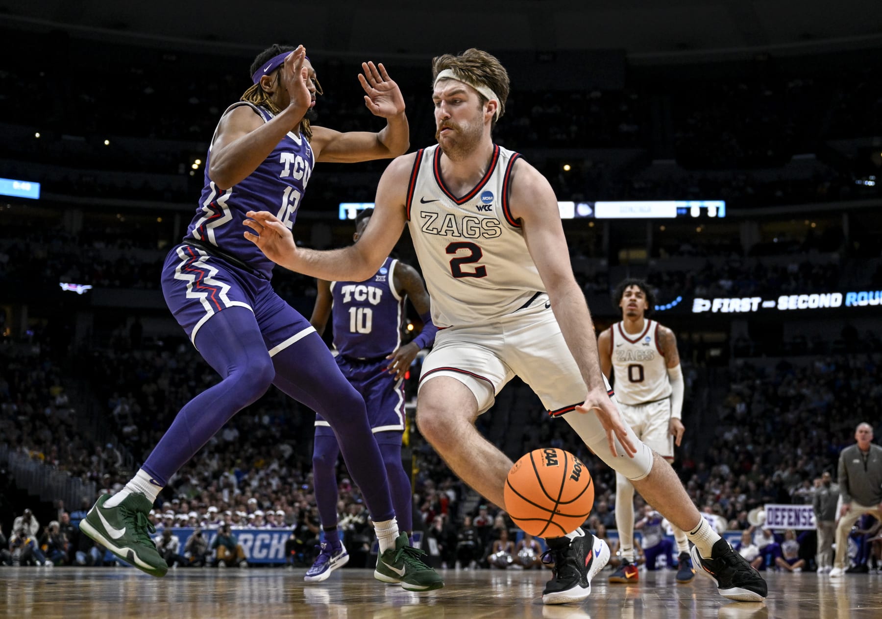 DENVER, CO - MARCH 19: Drew Timme (2) of the Gonzaga Bulldogs drives on Xavier Cork (12) of the TCU Horned Frogs during the second half of Gonzagas 84-81 second round NCAA mens basketball tournament game win at Ball Arena in Denver on Sunday, March 19, 2023. (Photo by AAron Ontiveroz/MediaNews Group/The Denver Post via Getty Images)
