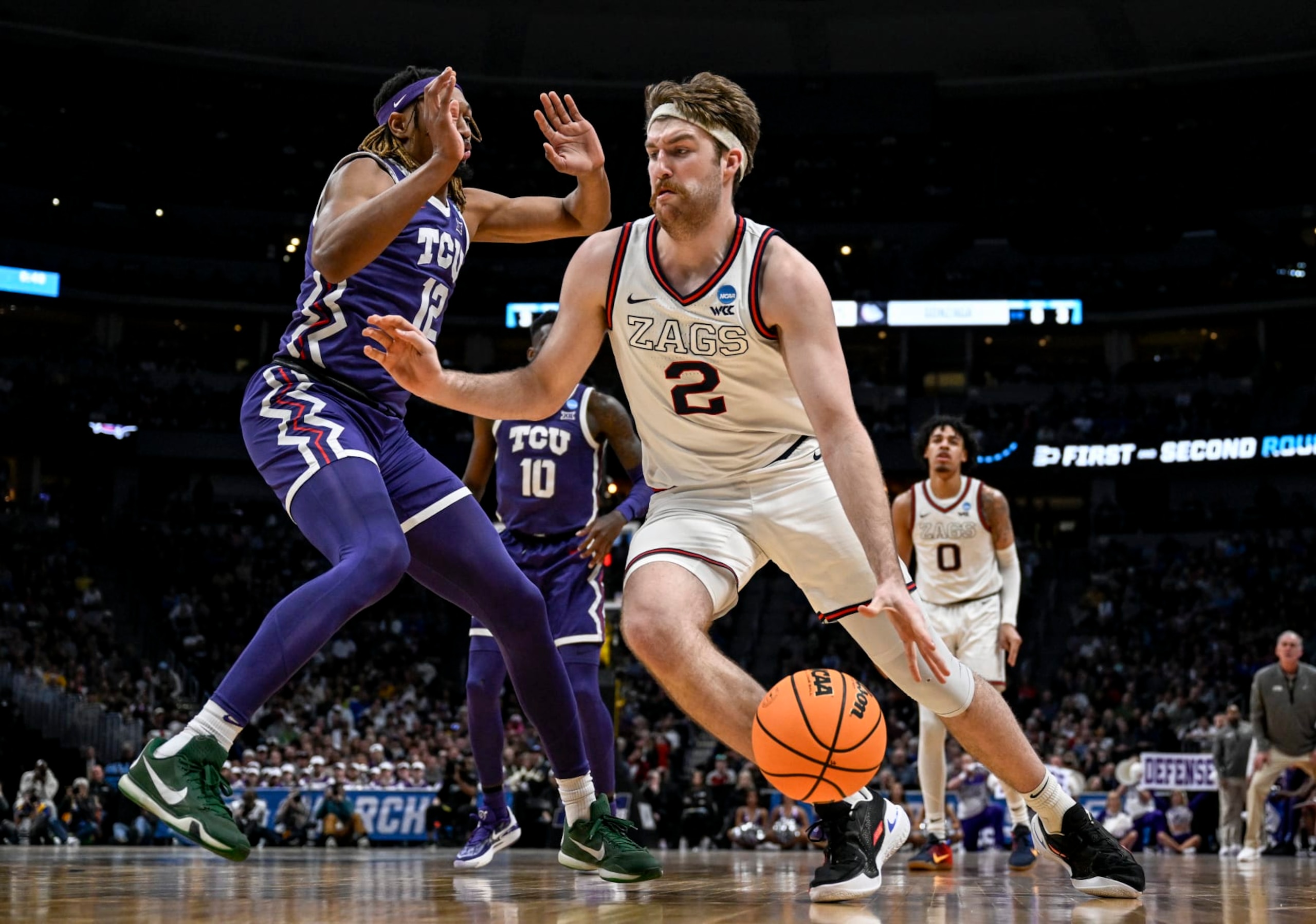 DENVER, CO - MARCH 19: Drew Timme (2) of the Gonzaga Bulldogs drives on Xavier Cork (12) of the TCU Horned Frogs during the second half of Gonzagas 84-81 second round NCAA mens basketball tournament game win at Ball Arena in Denver on Sunday, March 19, 2023. (Photo by AAron Ontiveroz/MediaNews Group/The Denver Post via Getty Images)