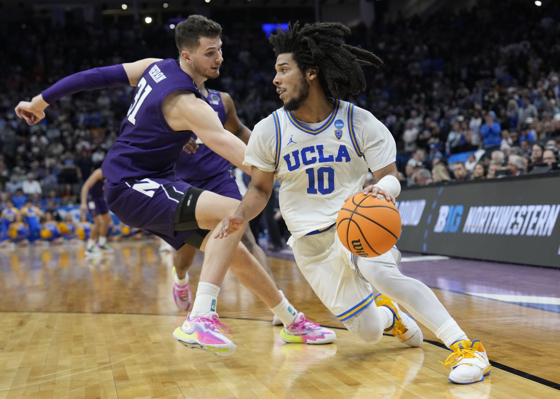 SACRAMENTO, CALIFORNIA - MARCH 18: Tyger Campbell #10 of the UCLA Bruins drives against Robbie Beran #31 of the Northwestern Wildcats during the second half in the second round of the NCAA Men's Basketball Tournament at Golden 1 Center on March 18, 2023 in Sacramento, California. (Photo by Thearon W. Henderson/Getty Images)
