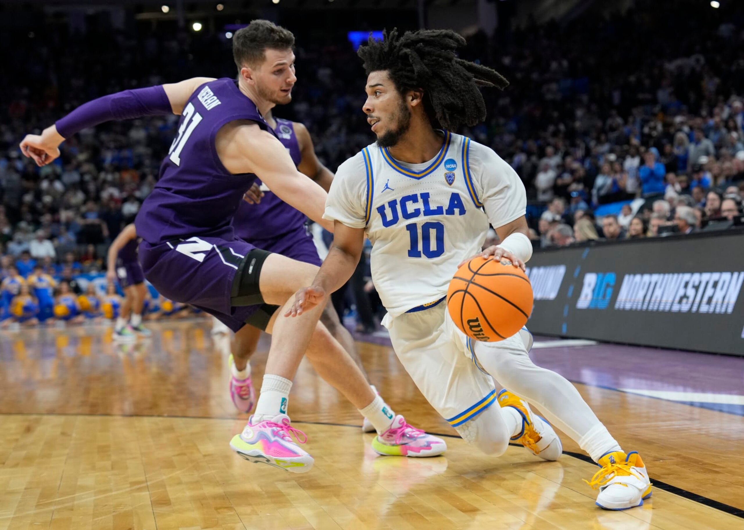 SACRAMENTO, CALIFORNIA - MARCH 18: Tyger Campbell #10 of the UCLA Bruins drives against Robbie Beran #31 of the Northwestern Wildcats during the second half in the second round of the NCAA Men's Basketball Tournament at Golden 1 Center on March 18, 2023 in Sacramento, California. (Photo by Thearon W. Henderson/Getty Images)