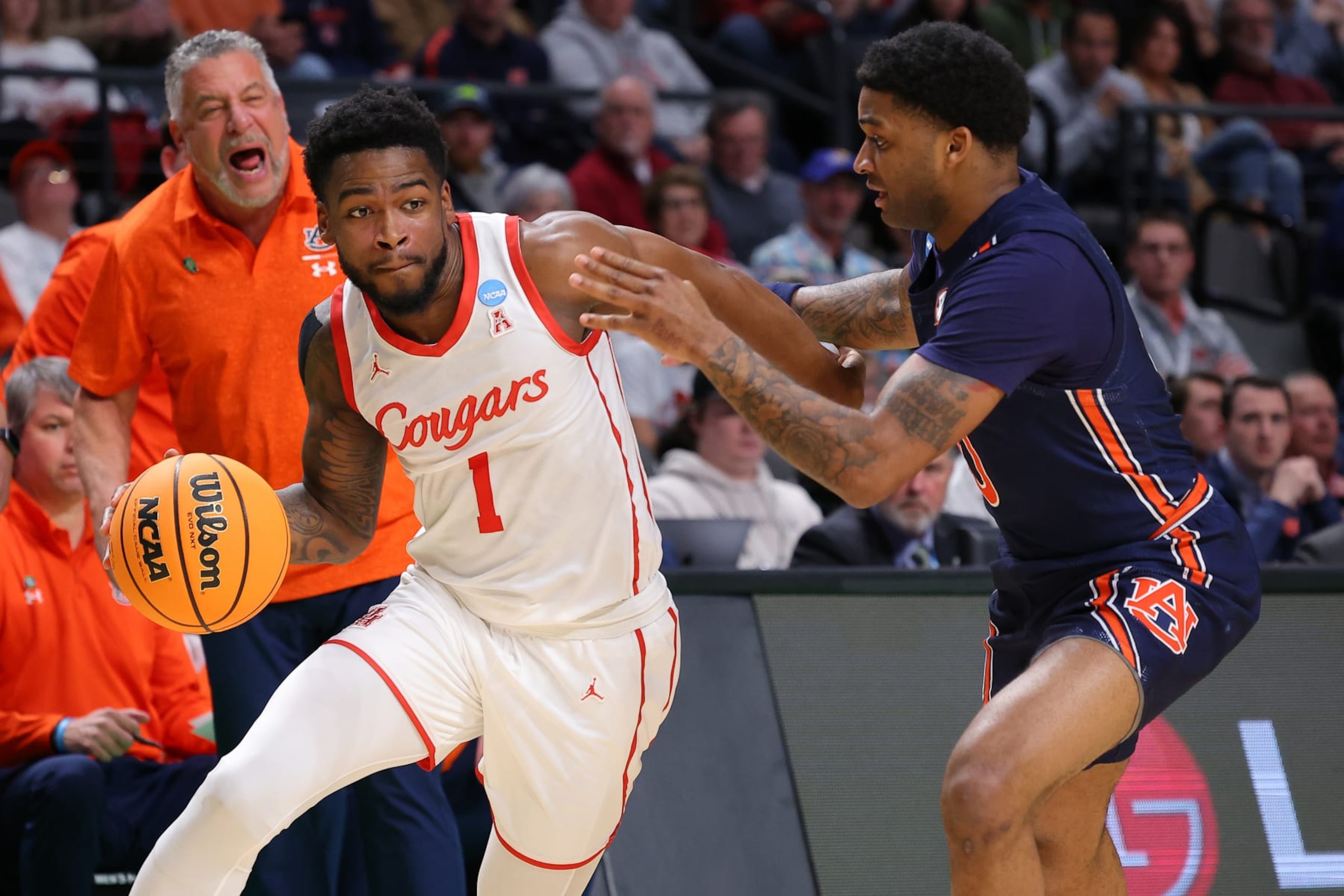 BIRMINGHAM, ALABAMA - MARCH 18: Jamal Shead #1 of the Houston Cougars drives the ball against K.D. Johnson #0 of the Auburn Tigers during the first half in the second round of the NCAA Men's Basketball Tournament at Legacy Arena at the BJCC on March 18, 2023 in Birmingham, Alabama. (Photo by Kevin C. Cox/Getty Images)