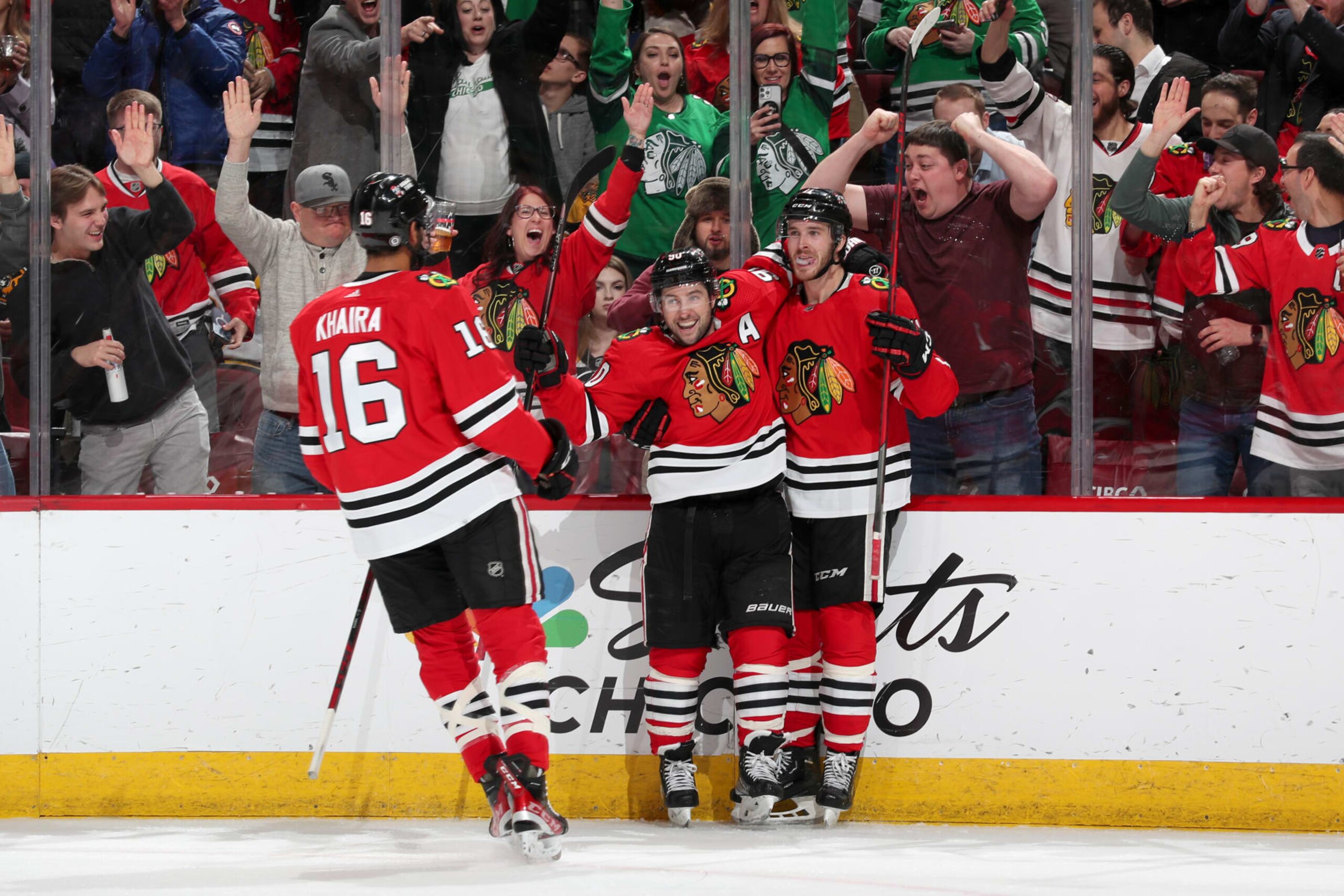 CHICAGO, ILLINOIS - MARCH 14: Taylor Raddysh #11 and Tyler Johnson #90 of the Chicago Blackhawks celebrate after Raddysh scores against the Boston Bruins in the third period at United Center on March 14, 2023 in Chicago, Illinois. (Photo by Chase Agnello-Dean/NHLI via Getty Images)