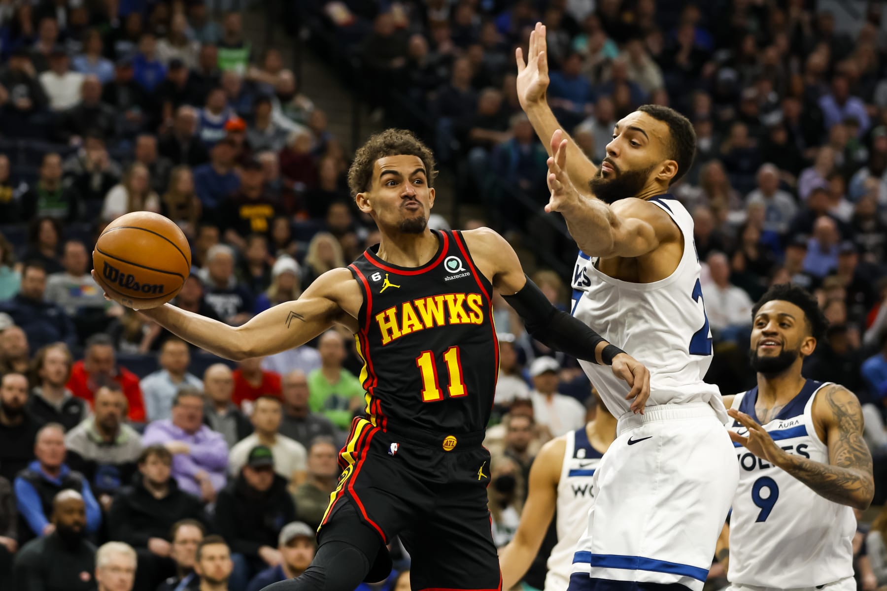 MINNEAPOLIS, MN - MARCH 22: Trae Young #11 of the Atlanta Hawks passes the ball while Rudy Gobert #27 of the Minnesota Timberwolves defends in the second quarter of the game at Target Center on March 22, 2023 in Minneapolis, Minnesota. NOTE TO USER: User expressly acknowledges and agrees that, by downloading and or using this Photograph, user is consenting to the terms and conditions of the Getty Images License Agreement. (Photo by David Berding/Getty Images)
