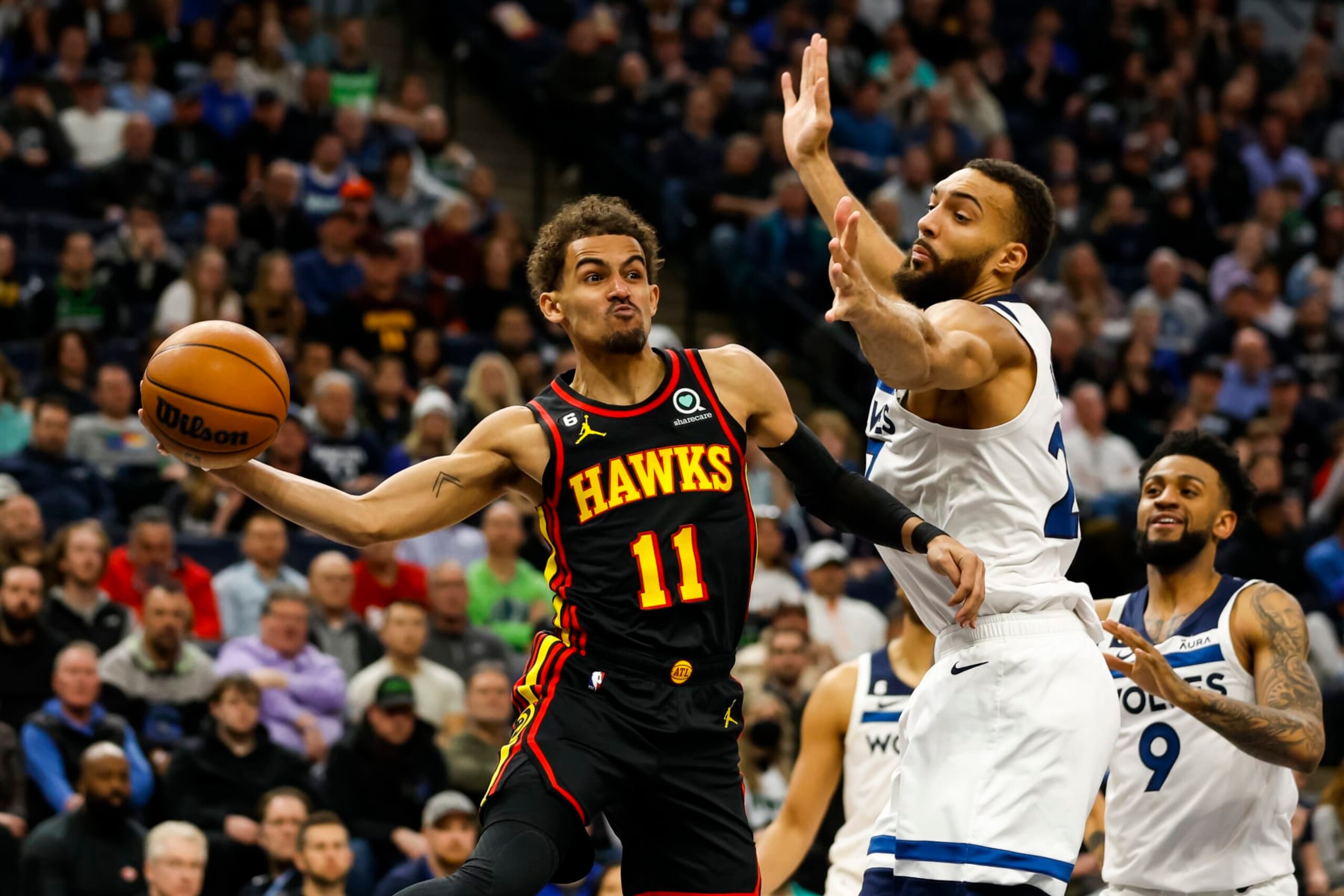 MINNEAPOLIS, MN - MARCH 22: Trae Young #11 of the Atlanta Hawks passes the ball while Rudy Gobert #27 of the Minnesota Timberwolves defends in the second quarter of the game at Target Center on March 22, 2023 in Minneapolis, Minnesota. NOTE TO USER: User expressly acknowledges and agrees that, by downloading and or using this Photograph, user is consenting to the terms and conditions of the Getty Images License Agreement. (Photo by David Berding/Getty Images)