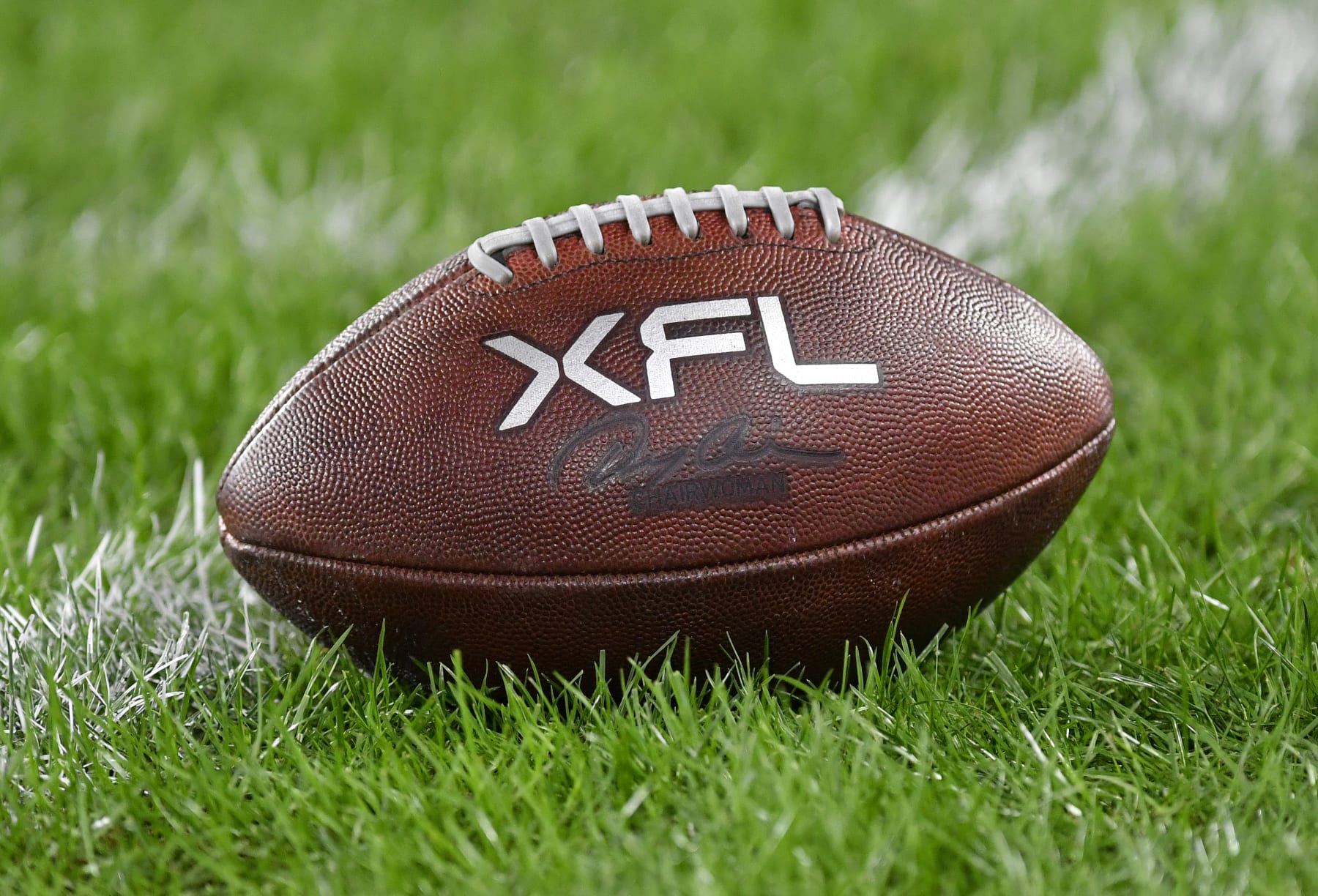 WASHINGTON, DC - FEBRUARY 19: A close up of an XFL leather game football on natural turf grass during the Seattle Sea Dragons versus D.C. Defenders XFL football game on February 19, 2023 at Audi Field in Washington, D.C.. (Photo by Randy Litzinger/Icon Sportswire via Getty Images)