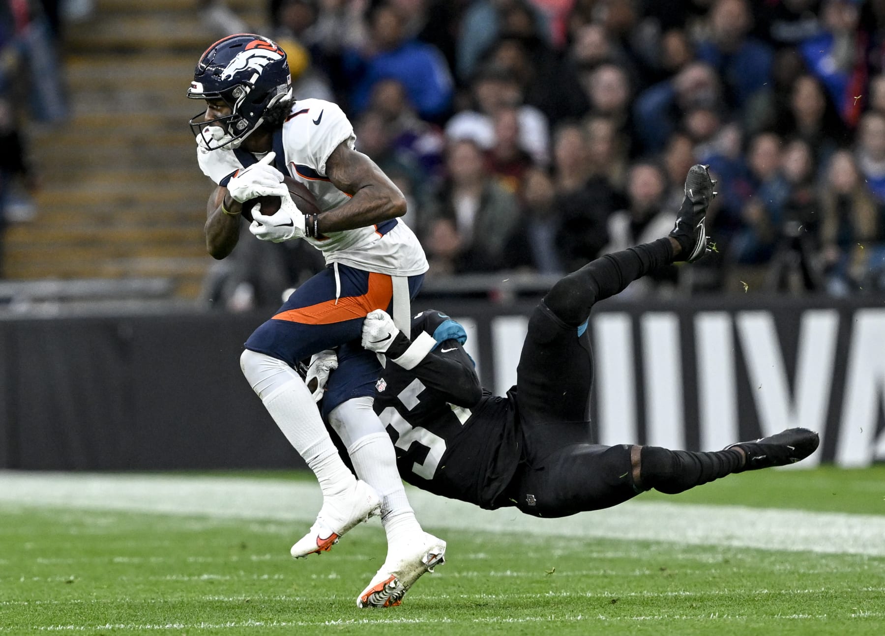 LONDON, U.K. - OCTOBER 30: KJ Hamler (1) of the Denver Broncos hauls in a long pass from Russell Wilson (3) as Tre Herndon (37) of the Jacksonville Jaguars defends during the fourth quarter of Denvers 21-17 win at Wembley Stadium in London on Sunday, October 30, 2022. (Photo by AAron Ontiveroz/MediaNews Group/The Denver Post via Getty Images)
