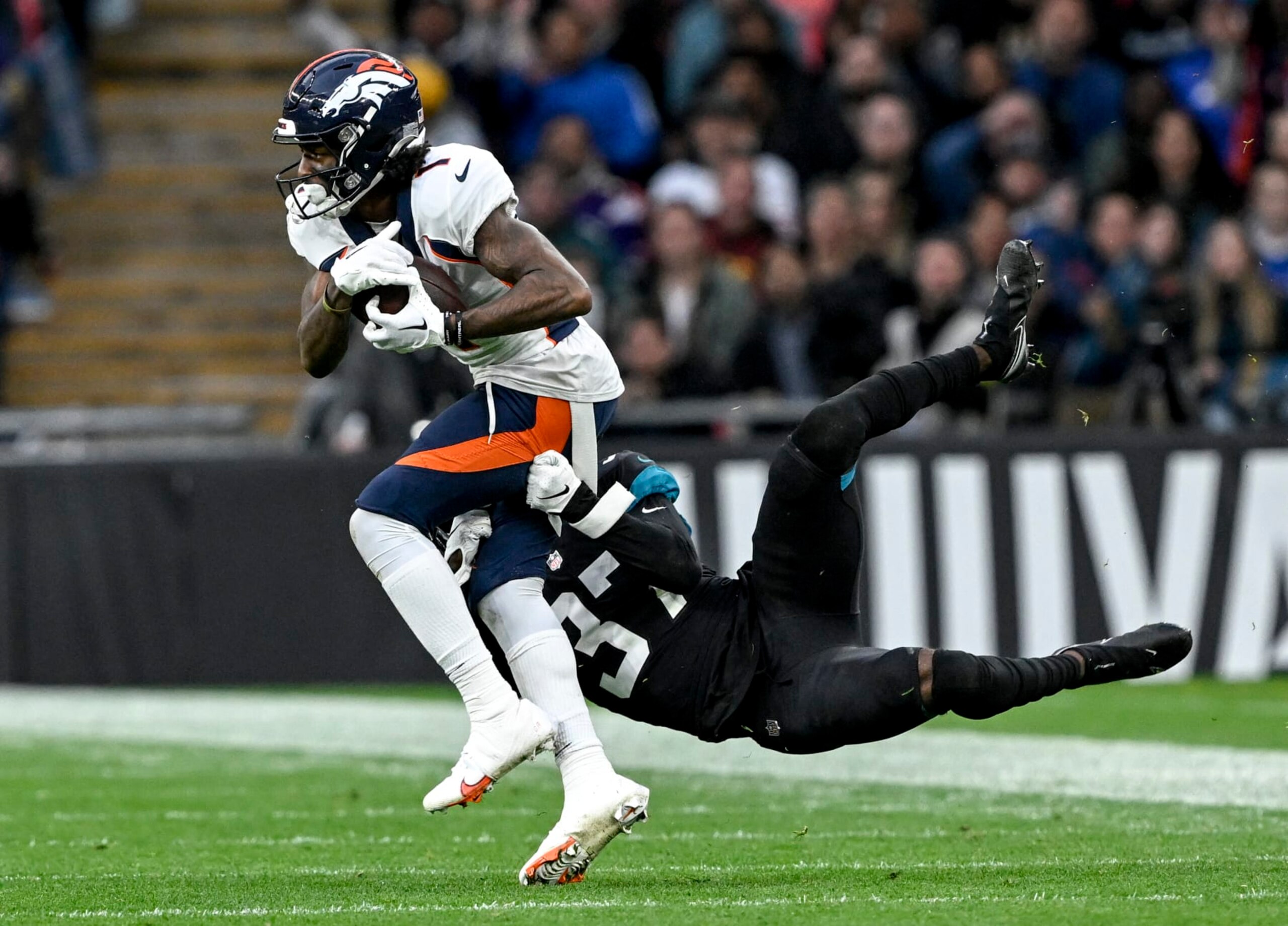LONDON, U.K. - OCTOBER 30: KJ Hamler (1) of the Denver Broncos hauls in a long pass from Russell Wilson (3) as Tre Herndon (37) of the Jacksonville Jaguars defends during the fourth quarter of Denvers 21-17 win at Wembley Stadium in London on Sunday, October 30, 2022. (Photo by AAron Ontiveroz/MediaNews Group/The Denver Post via Getty Images) LONDON, U.K. - OCTOBER 30: KJ Hamler (1) of the Denver Broncos hauls in a long pass from Russell Wilson (3) as Tre Herndon (37) of the Jacksonville Jaguars defends during the fourth quarter of Denvers 21-17 win at Wembley Stadium in London on Sunday, October 30, 2022. (Photo by AAron Ontiveroz/MediaNews Group/The Denver Post via Getty Images)