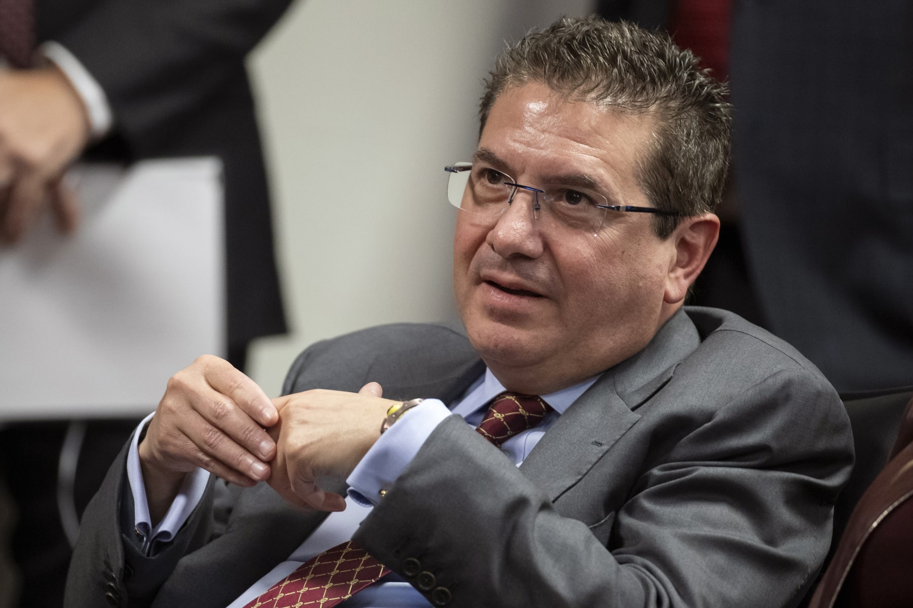 FILE - Washington NFL football team owner Dan Snyder listens to head coach Ron Rivera during a news conference at the team's NFL football training facility, in Ashburn, Va., Jan. 2, 2020. The Washington Commanders are denying the contents of a report about the team’s sale process. The team in a statement late Monday, Feb. 27, 2023, said a story published hours earlier by The Washington Post is “simply untrue.” (AP Photo/Alex Brandon, File)