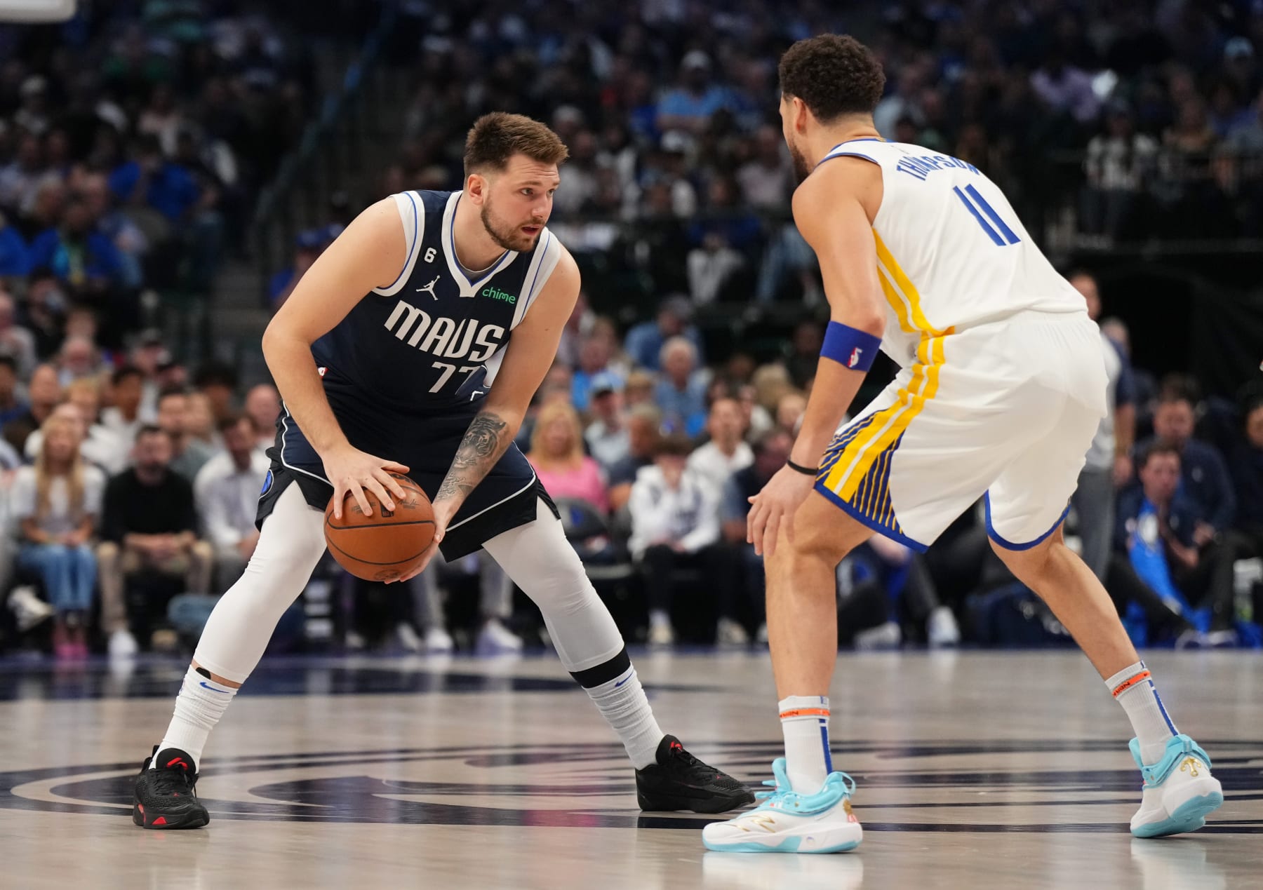 DALLAS, TX - MARCH 22:  Luka Doncic #77 of the Dallas Mavericks handles the ball against Klay Thompson #11 of the Golden State Warriors during the game on March 22, 2023 at the American Airlines Center in Dallas, Texas. NOTE TO USER: User expressly acknowledges and agrees that, by downloading and or using this photograph, User is consenting to the terms and conditions of the Getty Images License Agreement. Mandatory Copyright Notice: Copyright 2023 NBAE (Photo by Cooper Neill/NBAE via Getty Images)