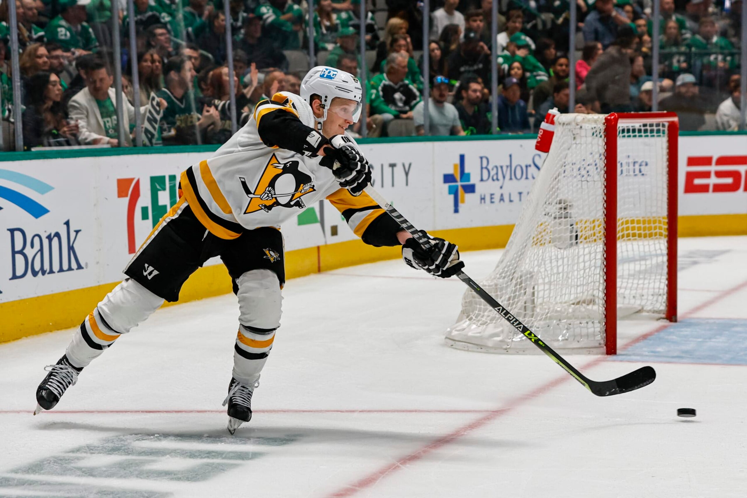 DALLAS, TX - MARCH 23: Pittsburgh Penguins left wing Jake Guentzel (59) passes the puck up the ice during the game between the Dallas Stars and the Pittsburgh Penguins on March 23, 2023 at the American Airlines Center in Dallas, Texas. (Photo by Matthew Pearce/Icon Sportswire via Getty Images)