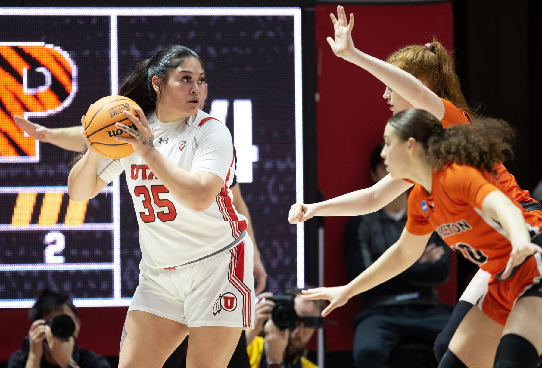 SALT LAKE CITY, UT- MARCH 19: Alissa Pili #35 of the Utah Utes is pressured by Grace Stone #10 and Parker Hill #22 of the Princeton Tigers during the first half of the second round of the NCAA Womens Basketball Tournament at the John M Huntsman Center March 19, 2023 in Salt Lake City, Utah.(Photo by Chris Gardner/Getty Images)