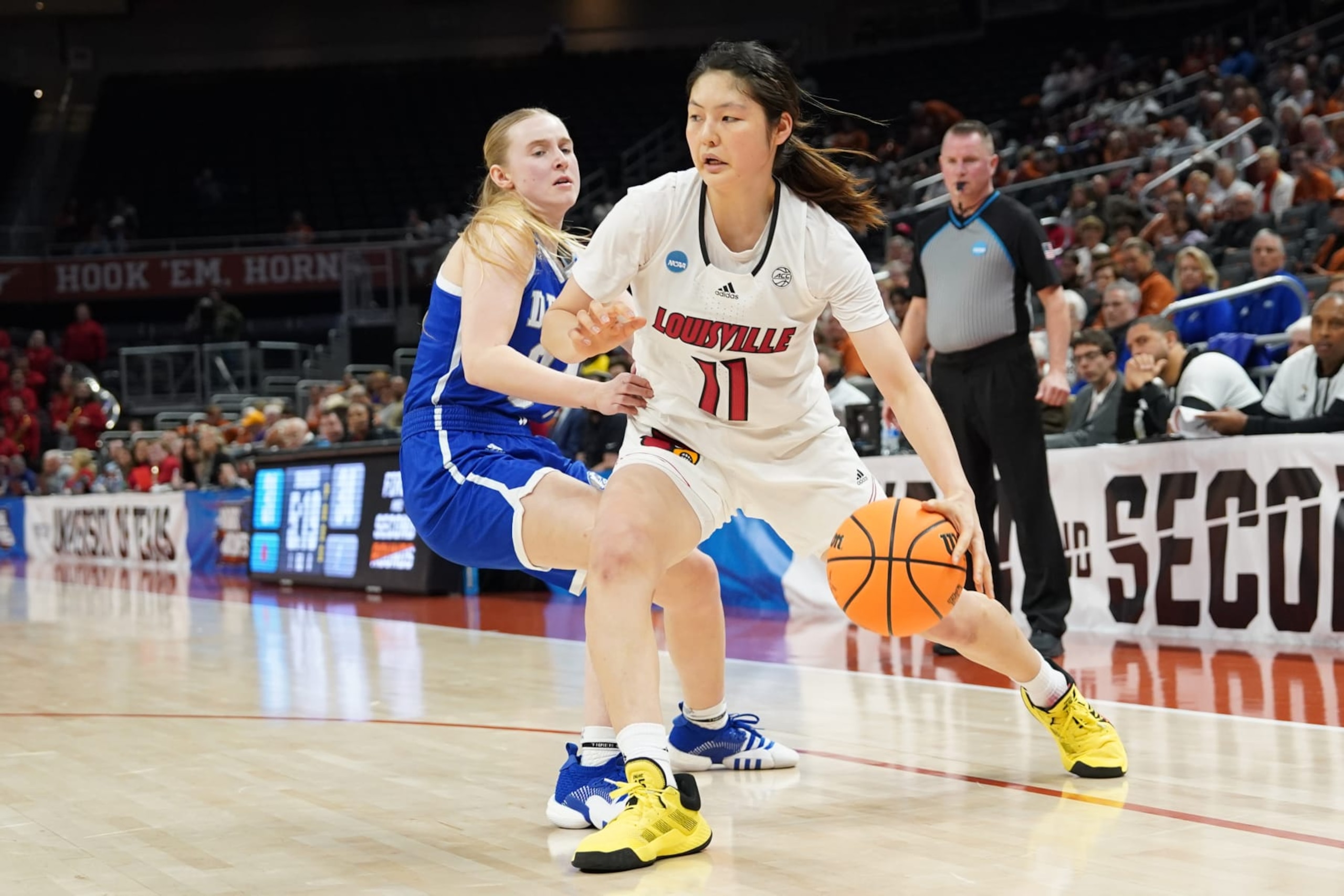 AUSTIN, TX - MARCH 18: Norika Konno #11 of the Louisville Cardinals takes the ball around a Drake player during the first round of the 2023 NCAA Women's Basketball Tournament held at the Moody Center on March 18, 2023 in Austin, Texas.  (Photo by Scott Wachter/NCAA Photos via Getty Images)