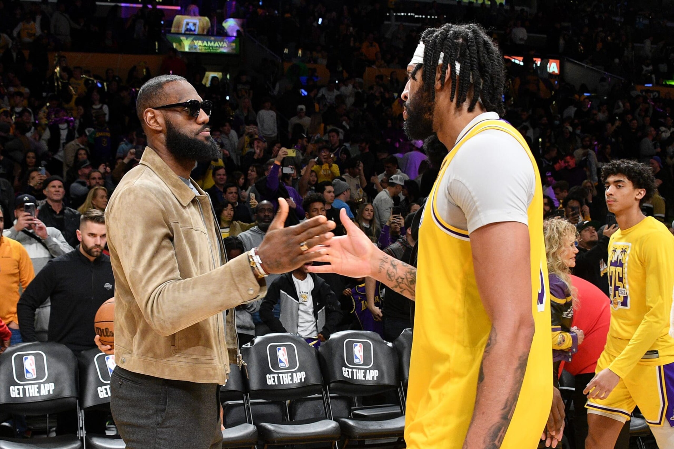 LOS ANGELES, CALIFORNIA - MARCH 22: Injured LeBron James congratulates Anthony Davis after the Los Angeles Lakers defeated the Phoenix Suns at Crypto.com Arena on March 22, 2023 in Los Angeles, California. (Photo by Allen Berezovsky/Getty Images)