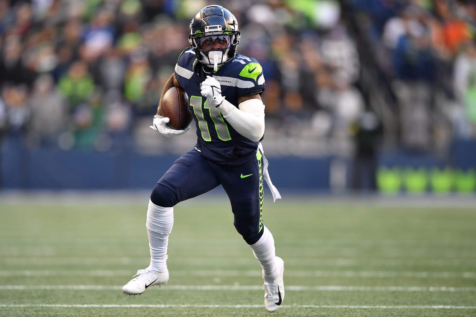 SEATTLE, WASHINGTON - NOVEMBER 27: Marquise Goodwin #11 of the Seattle Seahawks runs with the ball in the fourth quarter against the Las Vegas Raiders at Lumen Field on November 27, 2022 in Seattle, Washington. (Photo by Jane Gershovich/Getty Images)
